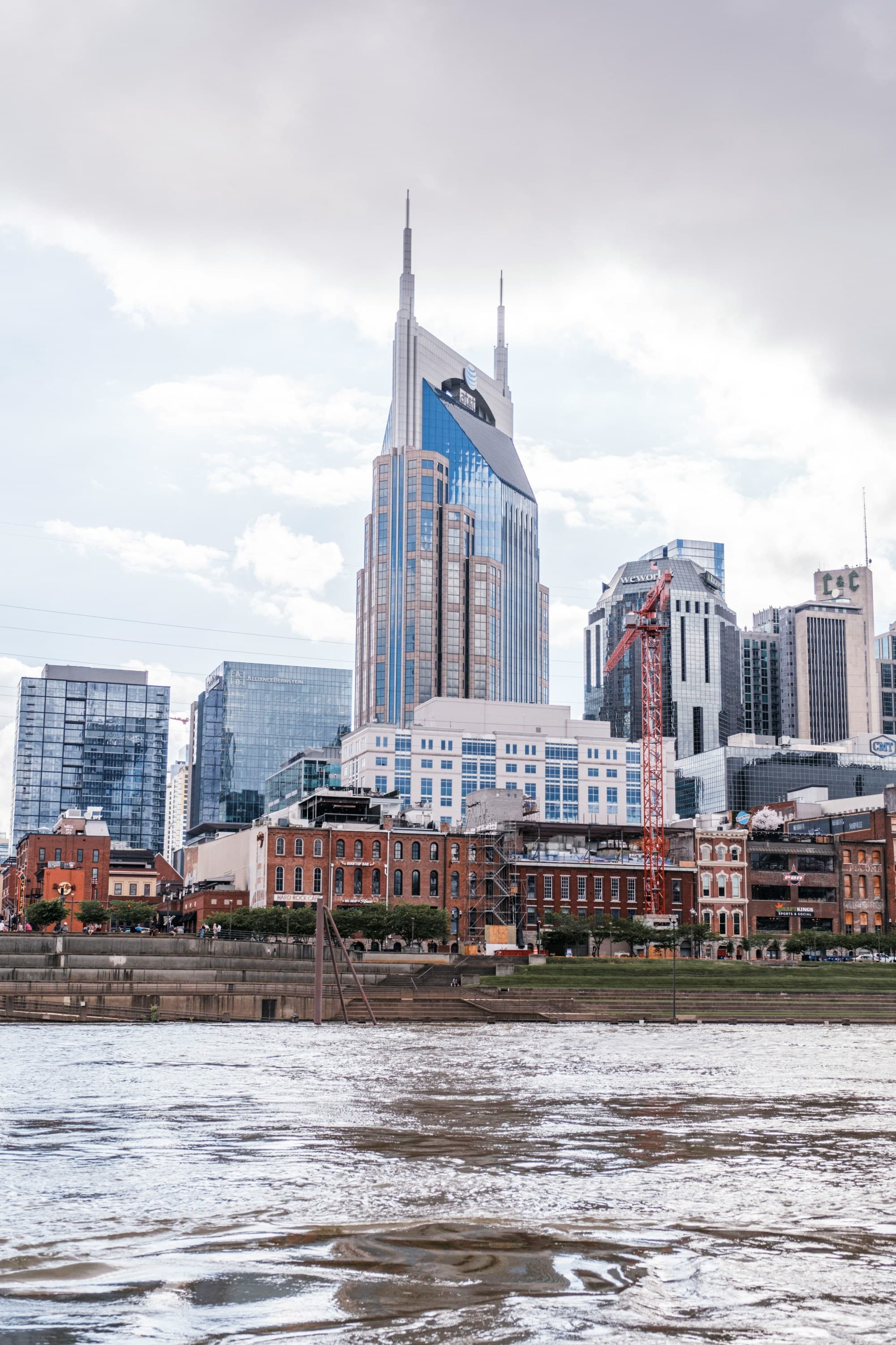 A body of water in front of tall city buildings during the daytime