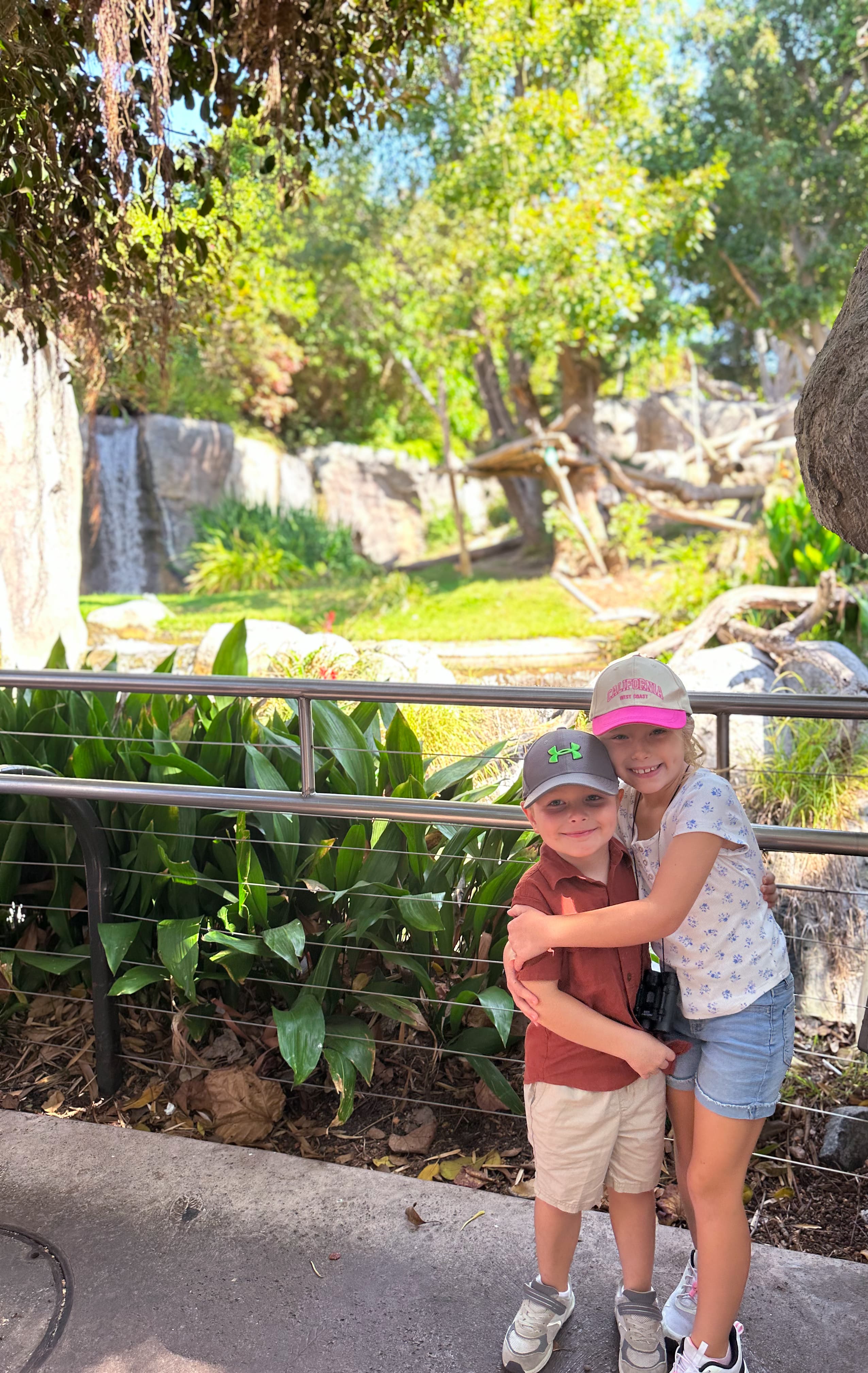 Two children posing at the zoo.