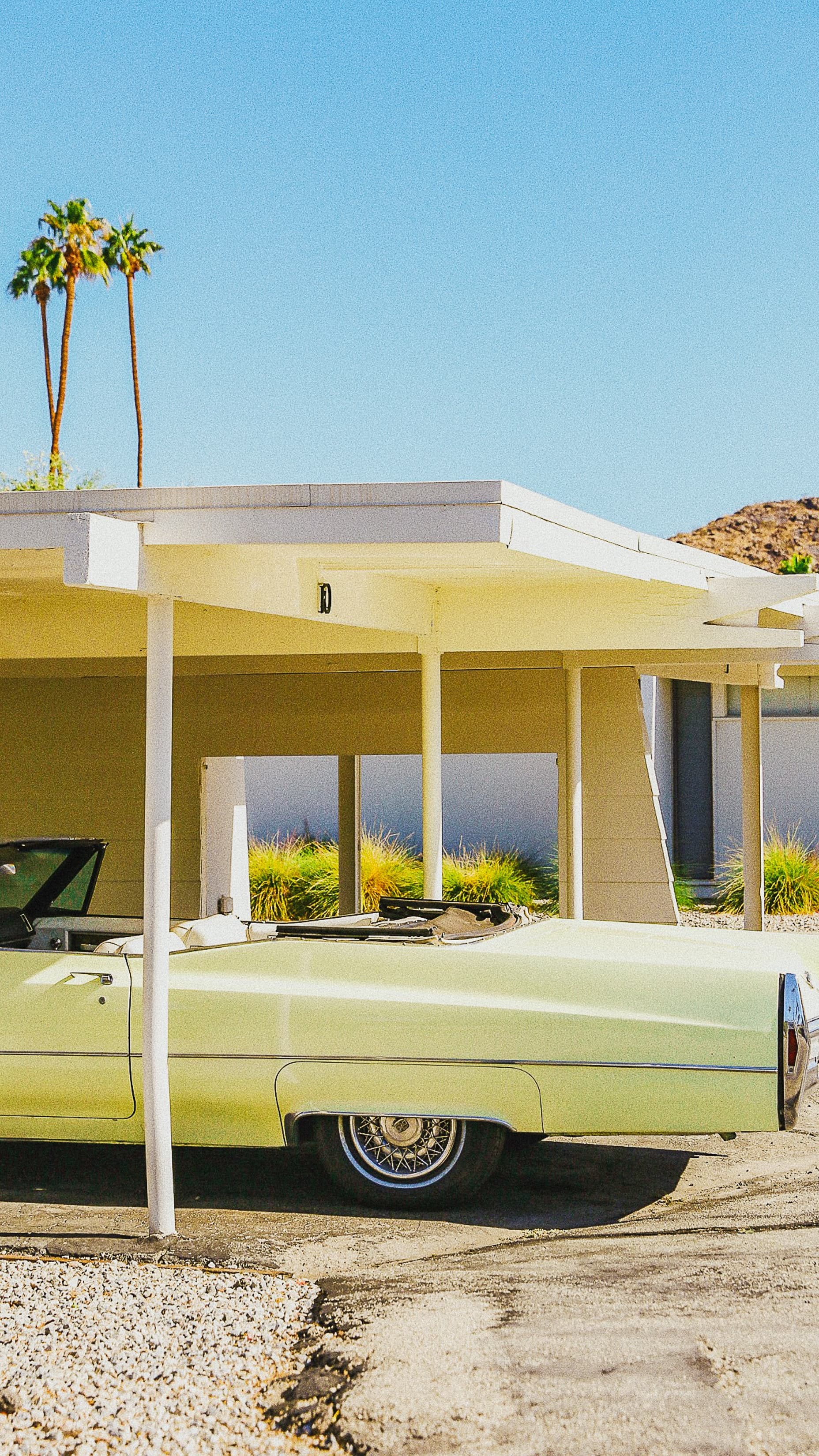 Yellow mid-century house and lime green vintage car in Palm Springs.