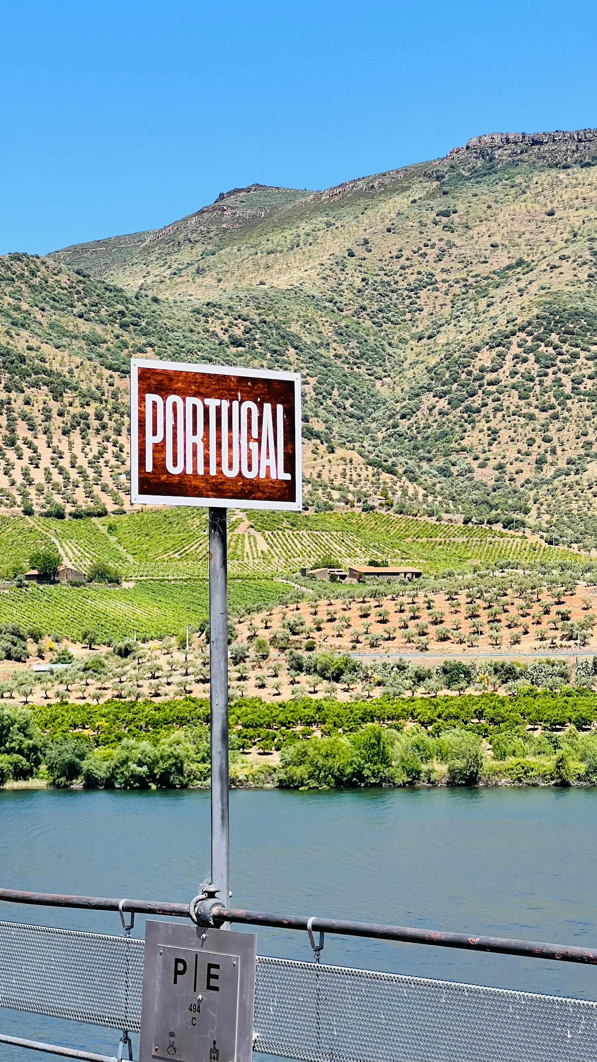 Signage in front of a hill in Portugal.