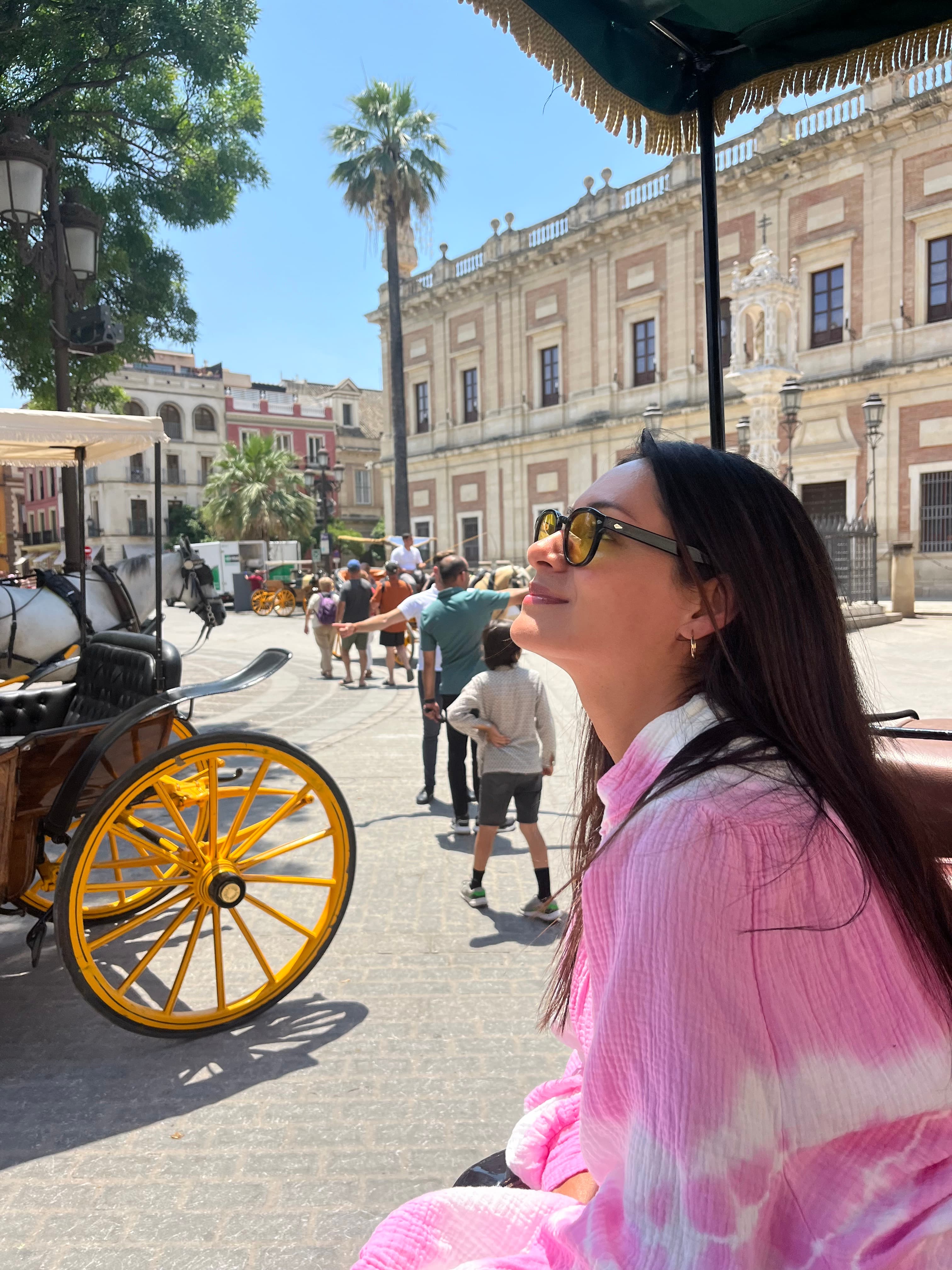 Advisor in a pink shirt on a sunny city street with her face to the sun