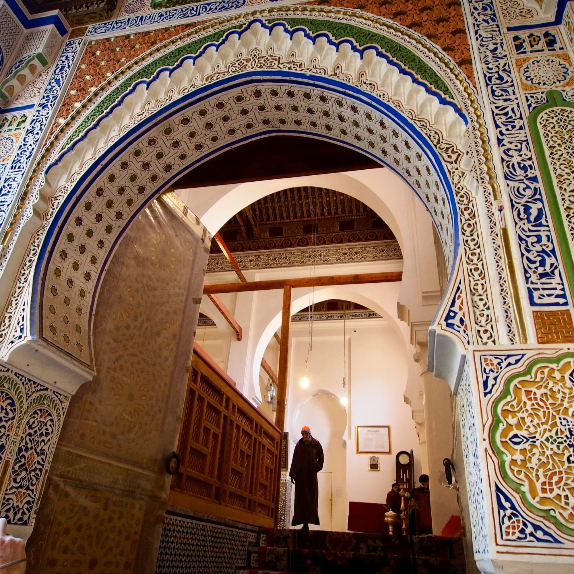 A vibrant cityscape at night with illuminated skyscrapers and bustling streets.