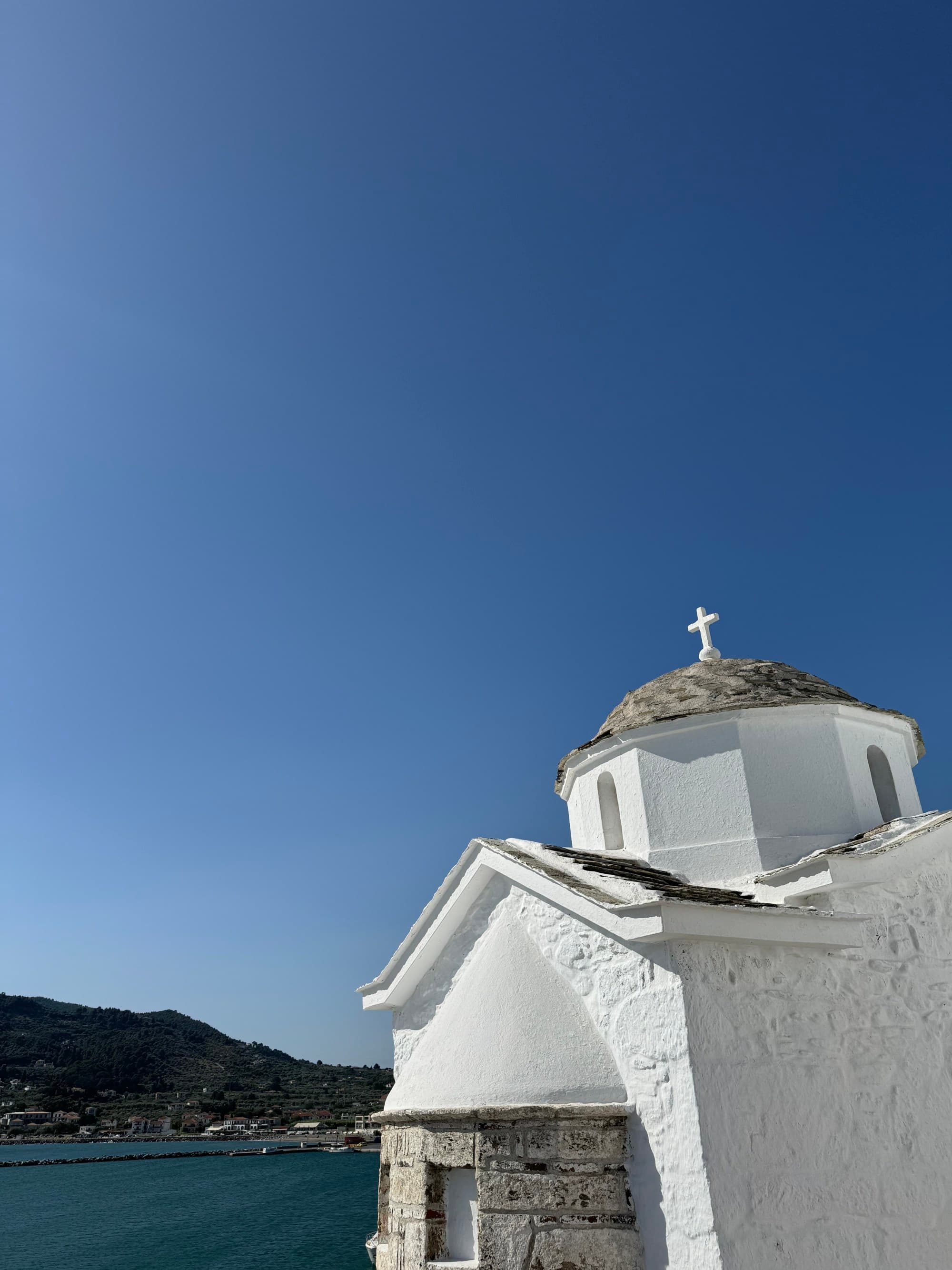 White church building with the ocean in the background