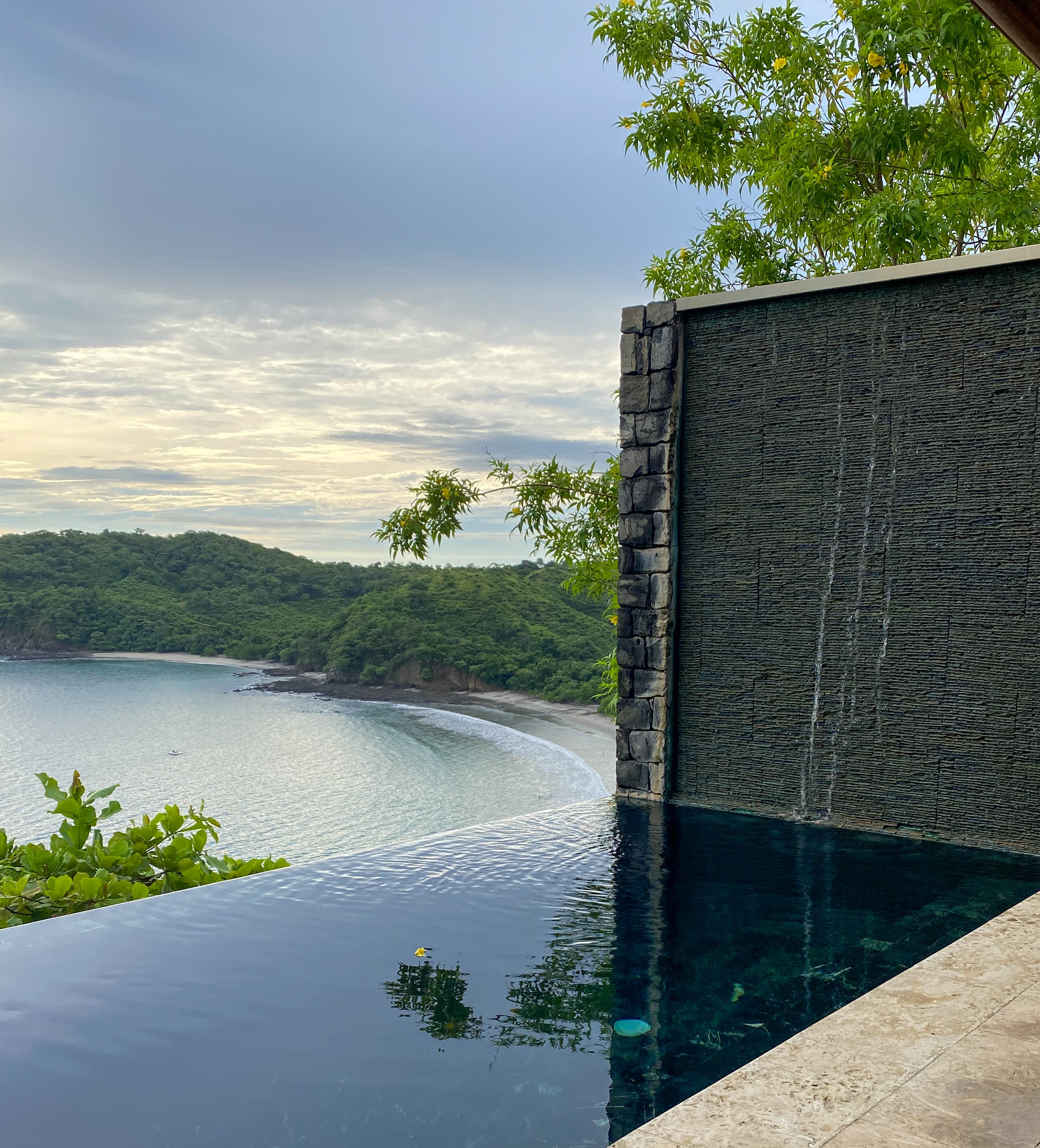 Villa plunge pool with a view of nature at Casa Chameleon on a cloudy day.