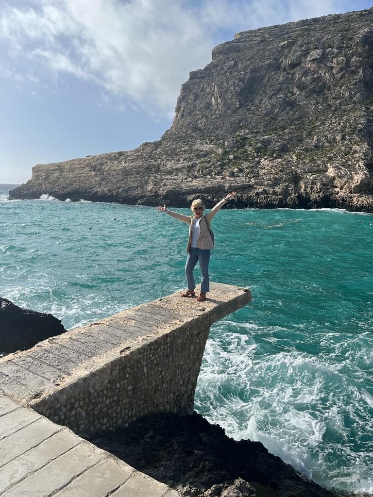 A woman standing and enjoying on deck.