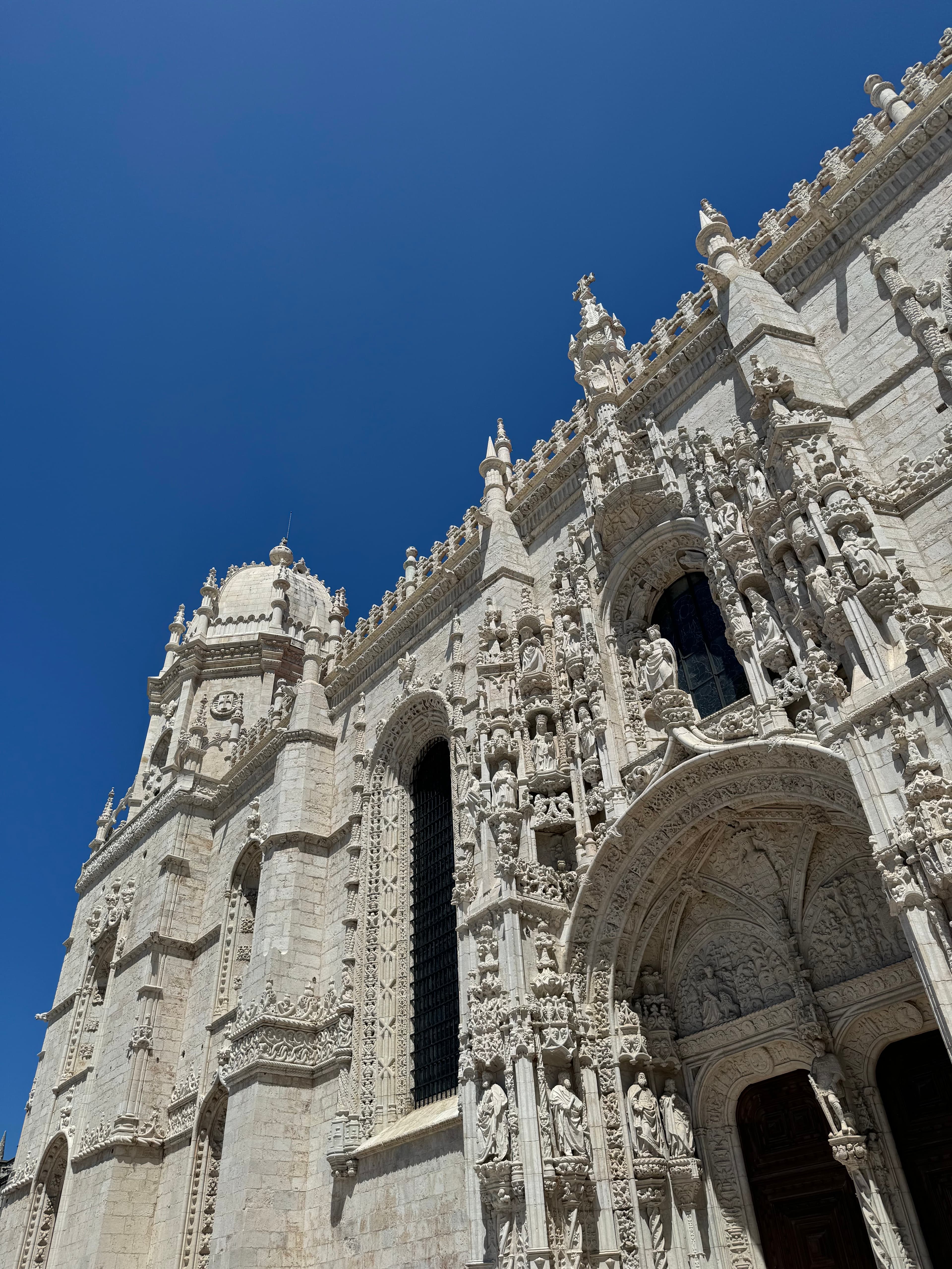 Amazing architecture in Lisbon reaches for the sky on a clear blue day.