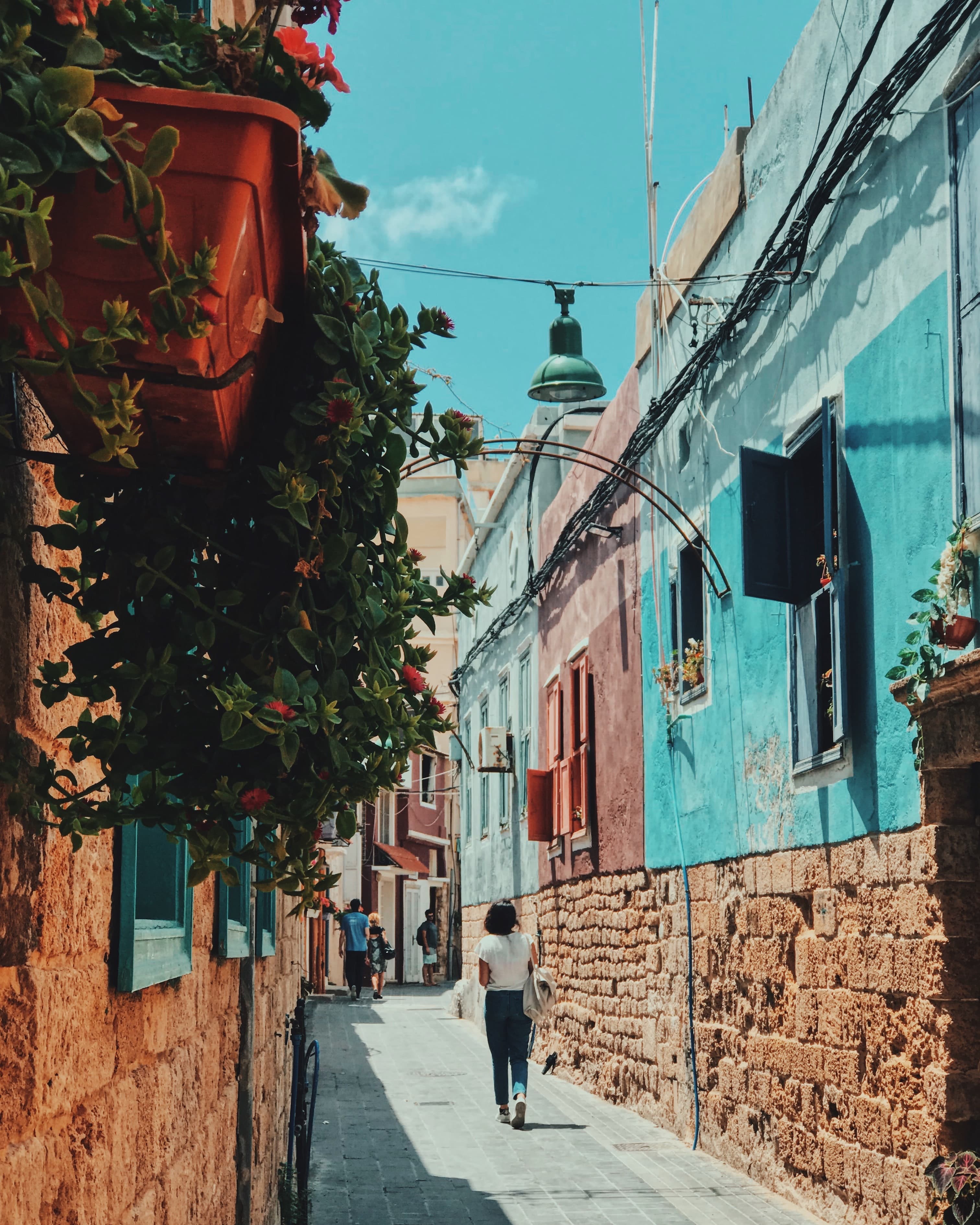 Girl walking down colorful street on a sunny day during daytime