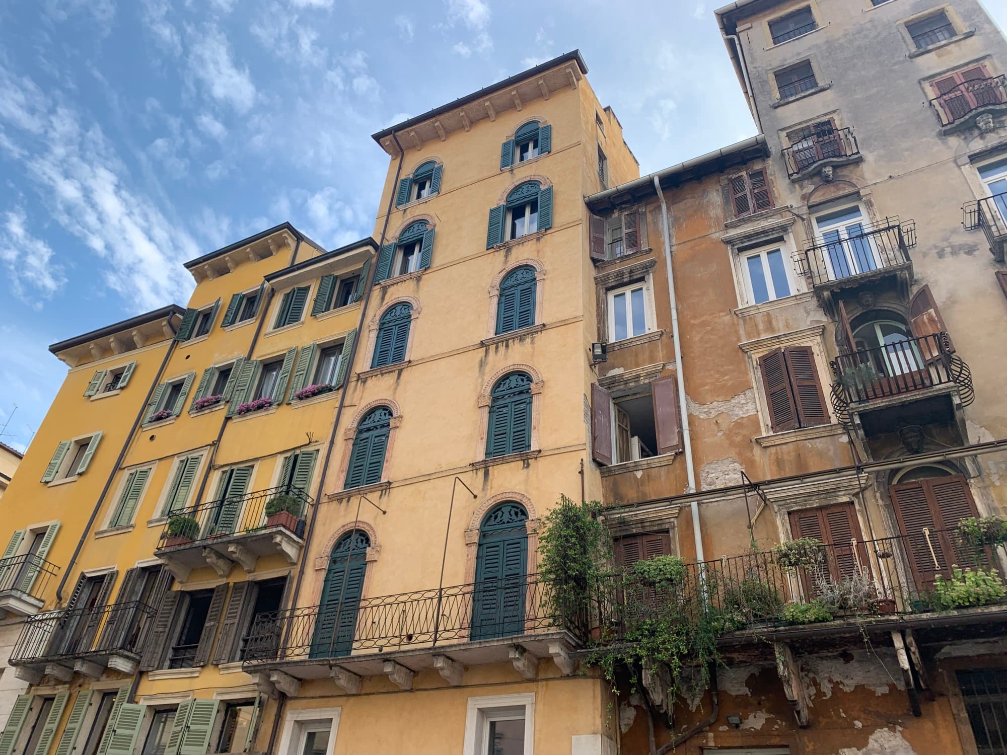 A picture of buildings taken from below a daytime.