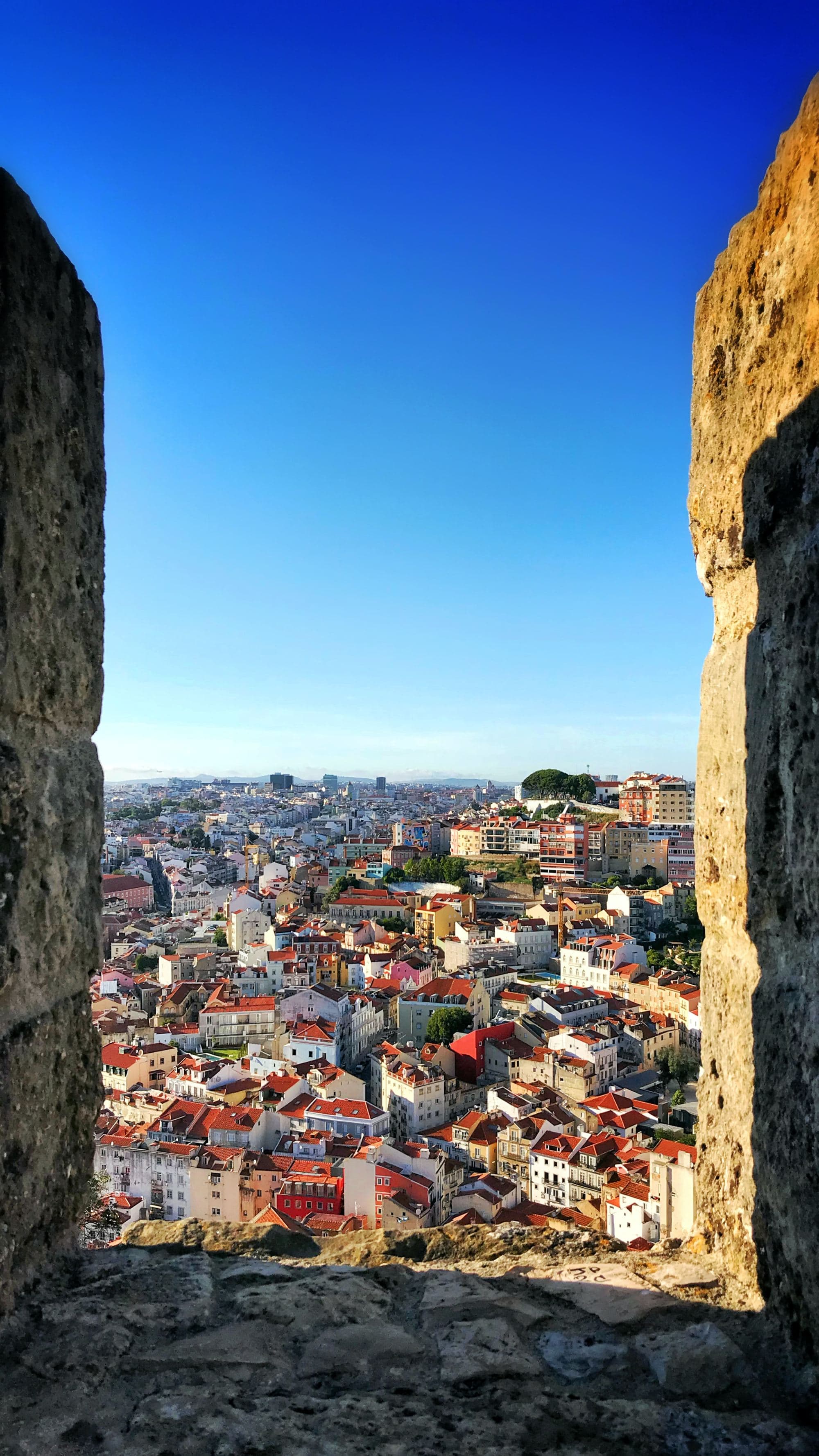 ancient city through stone wall with blue sky