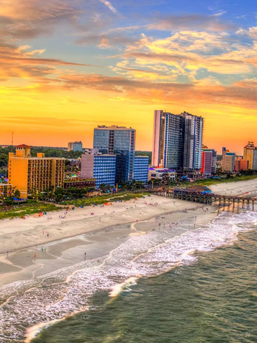 An aerial view of a beach next to a city scape