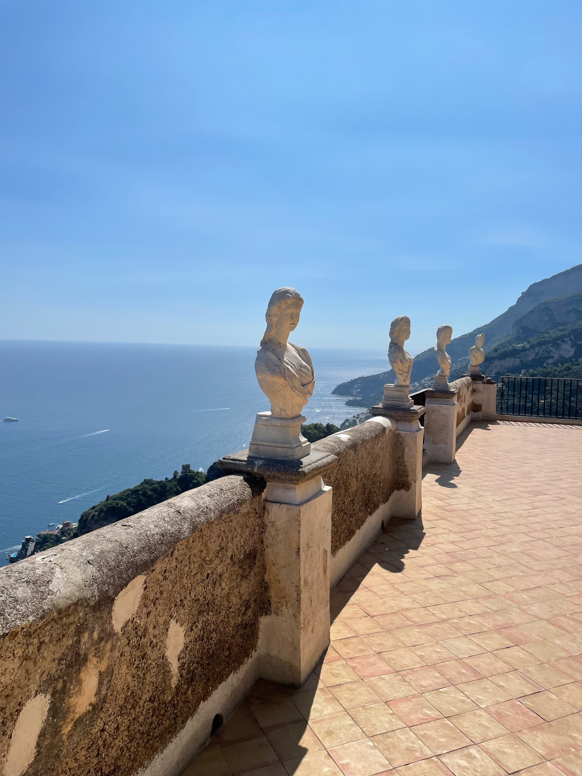 A picture of a terrace with statue of people.