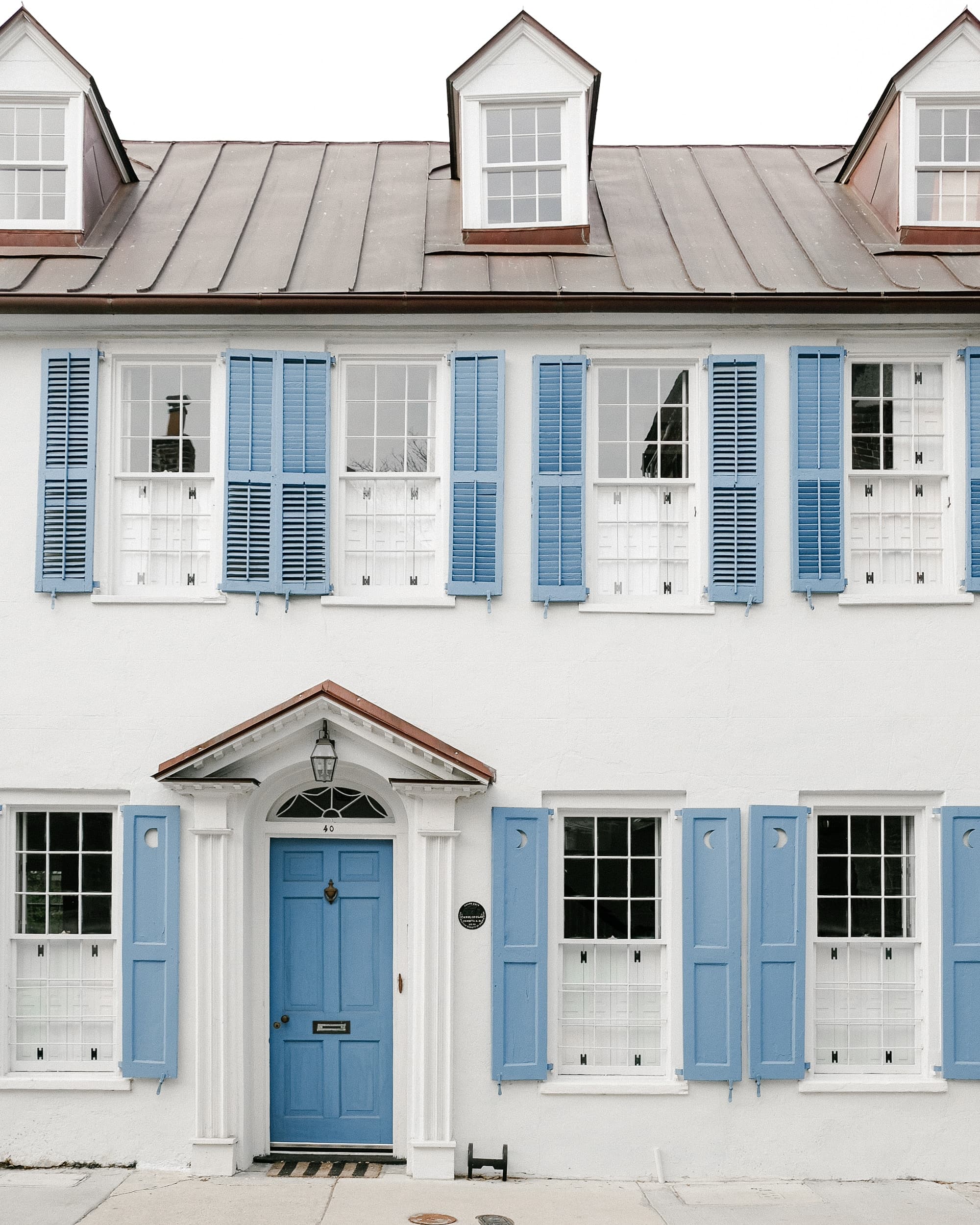 A blue and white concrete house at daytime.