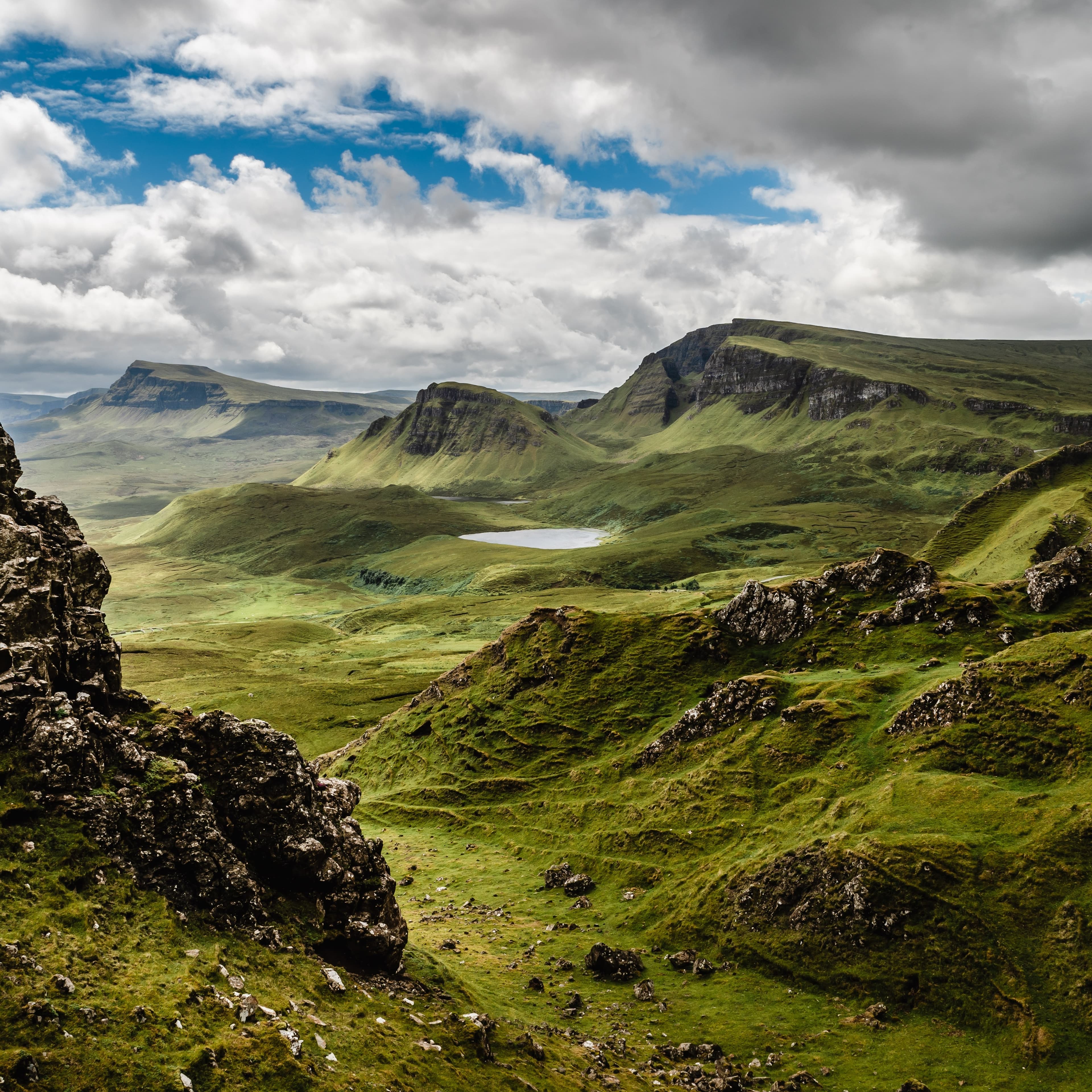 An aerial view of the green mountains at daytime.