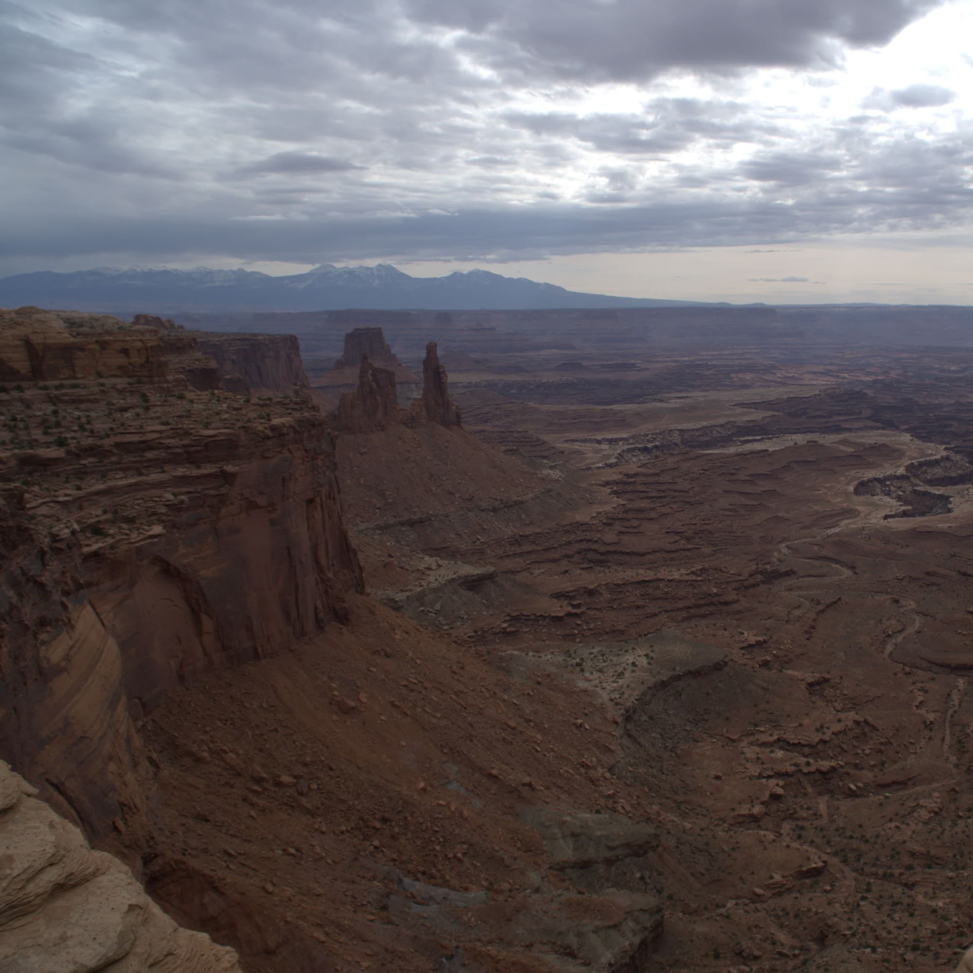 Brown steep area surrounded by rocky hills.