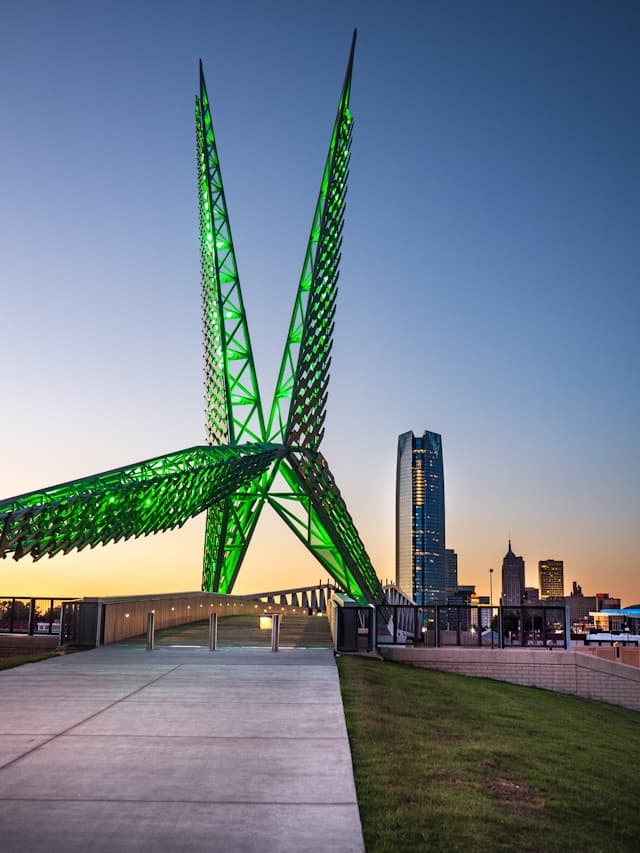 A green glass structure lit up at nighttime