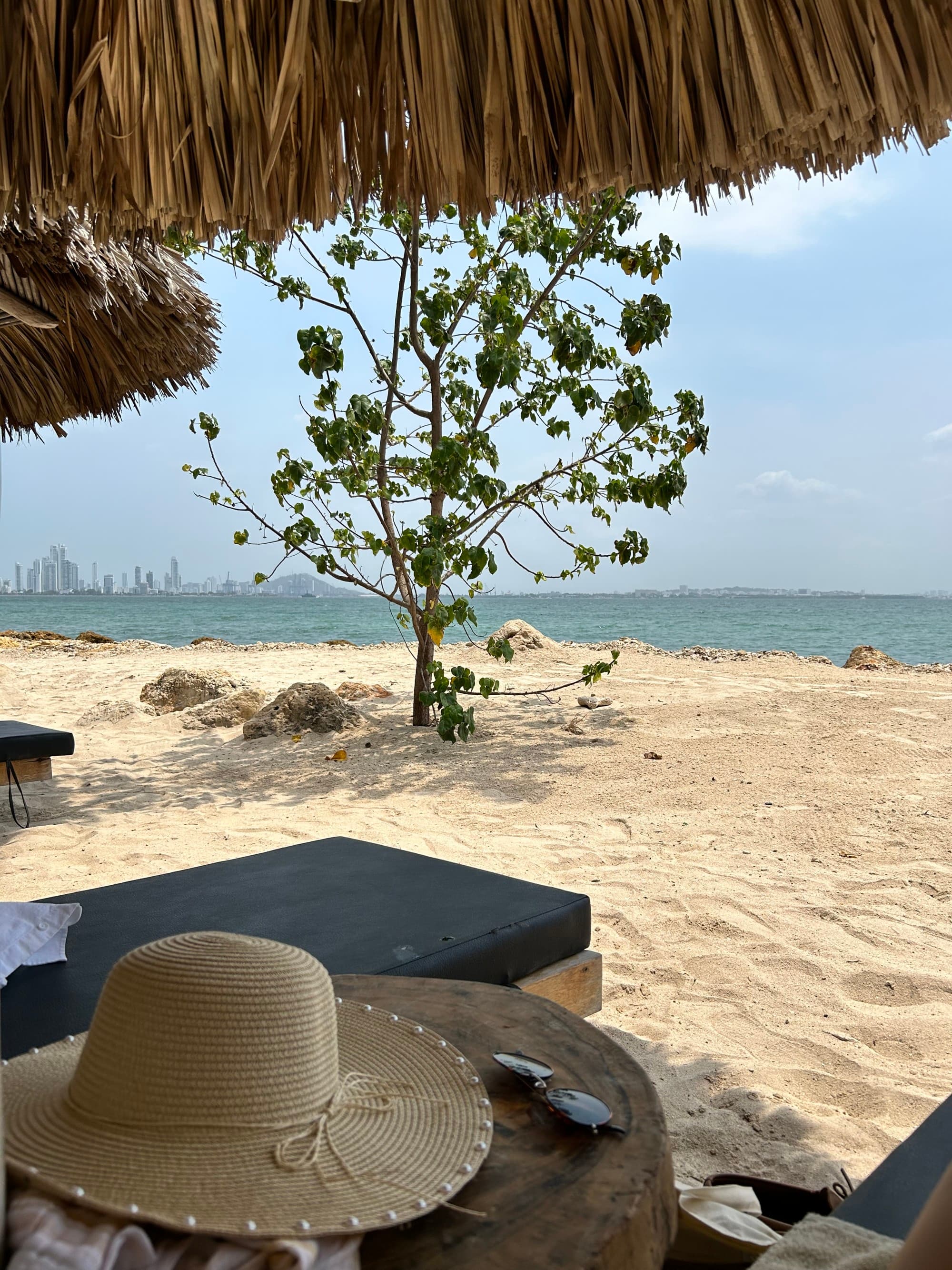 a hat on a beach table under umbrella