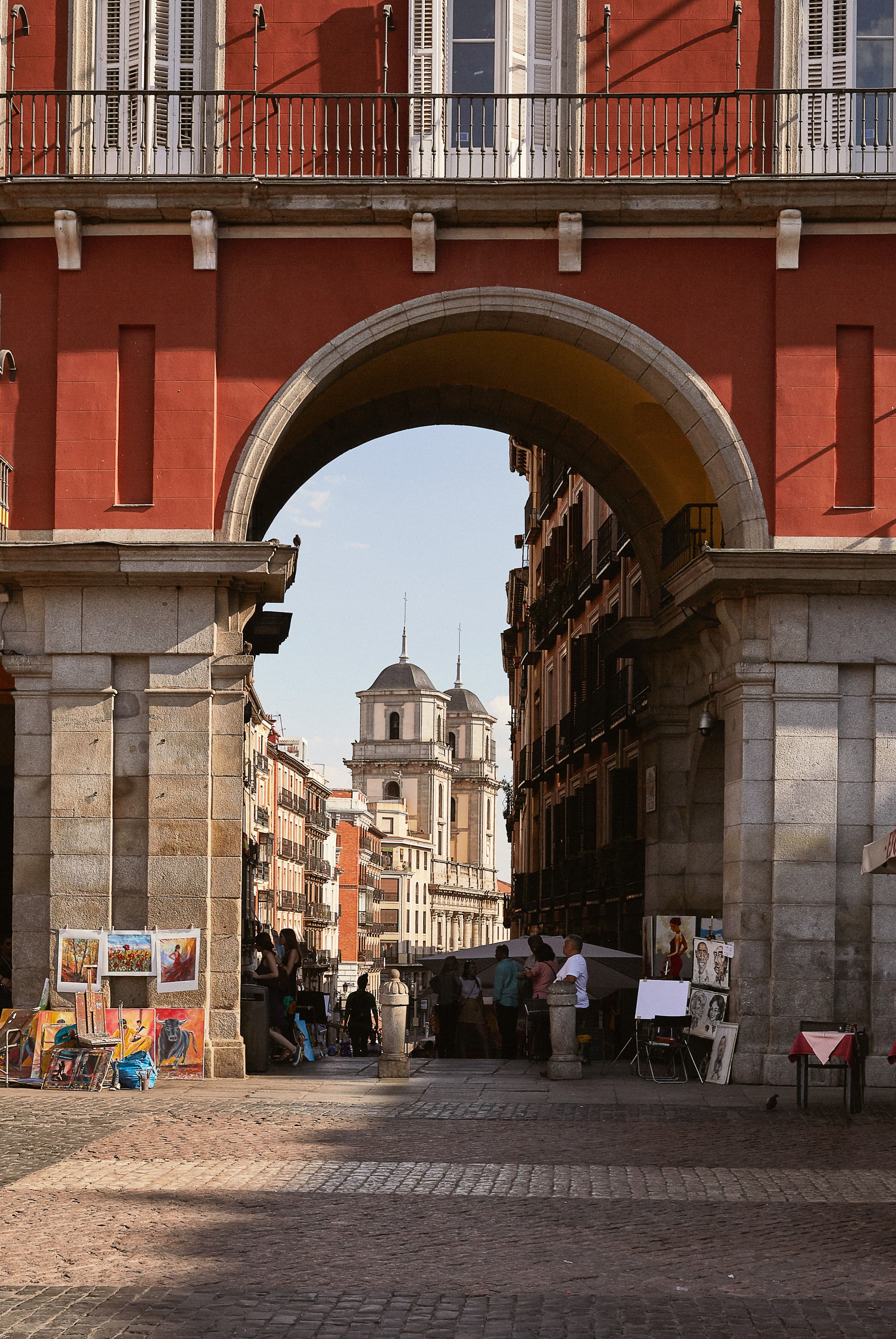 An antique building with street vendors in Madrid.