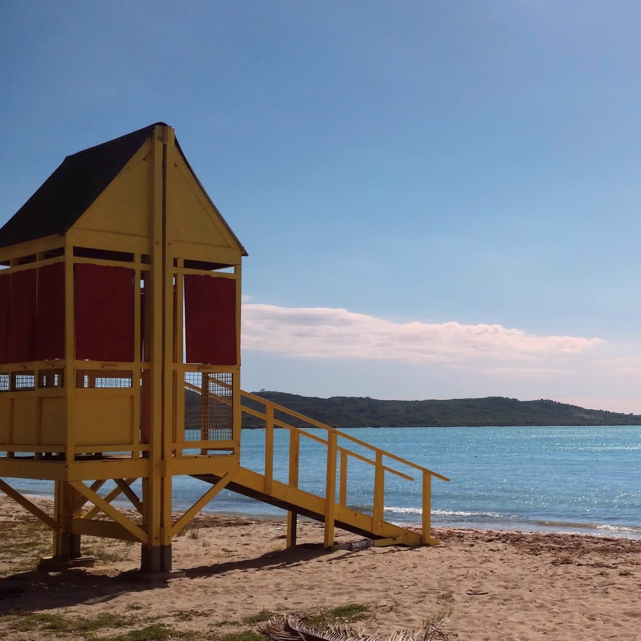 A wooden beach hut near the beach at daytime.