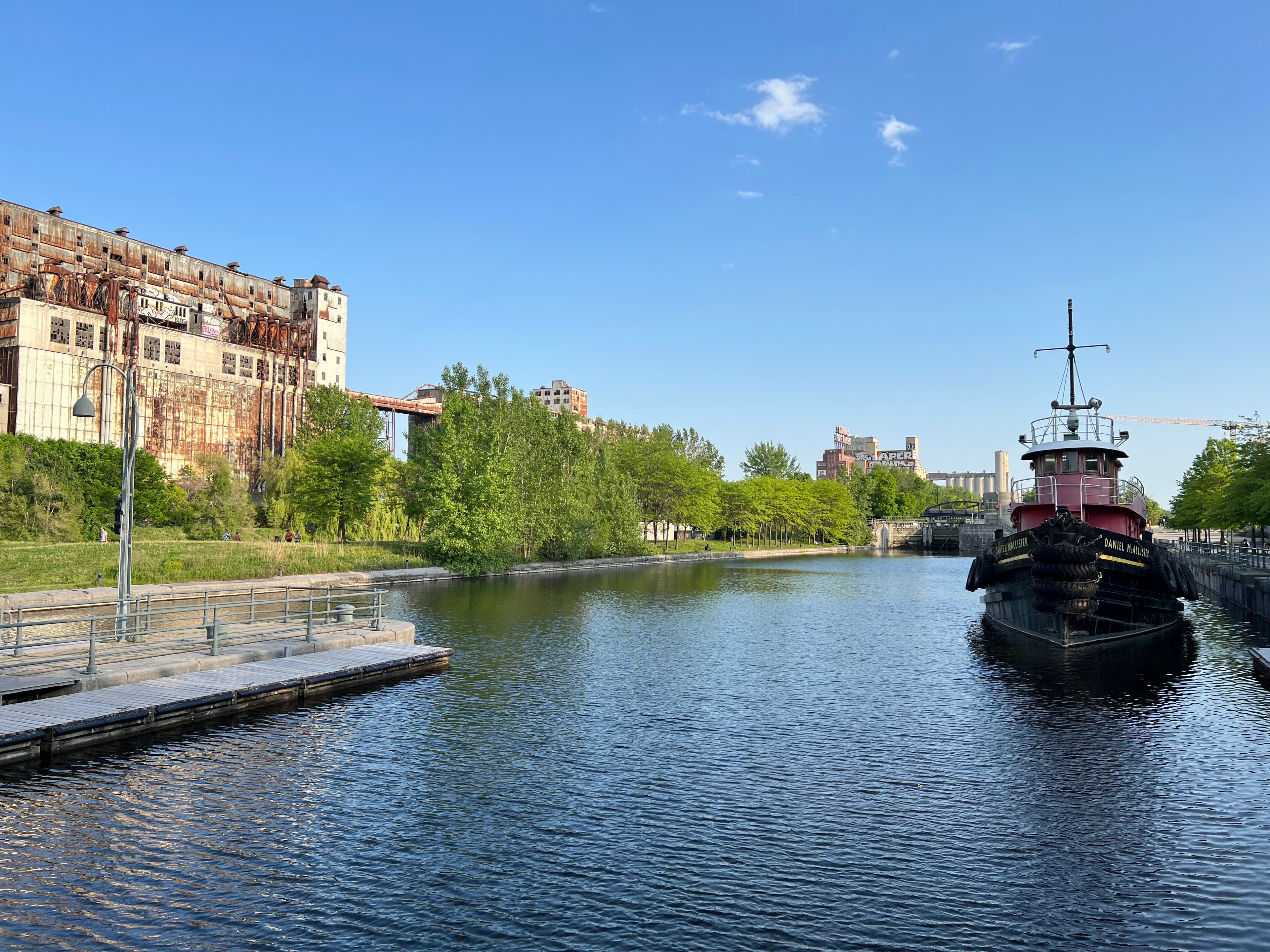 a row of brick townhouses on a sunny day.