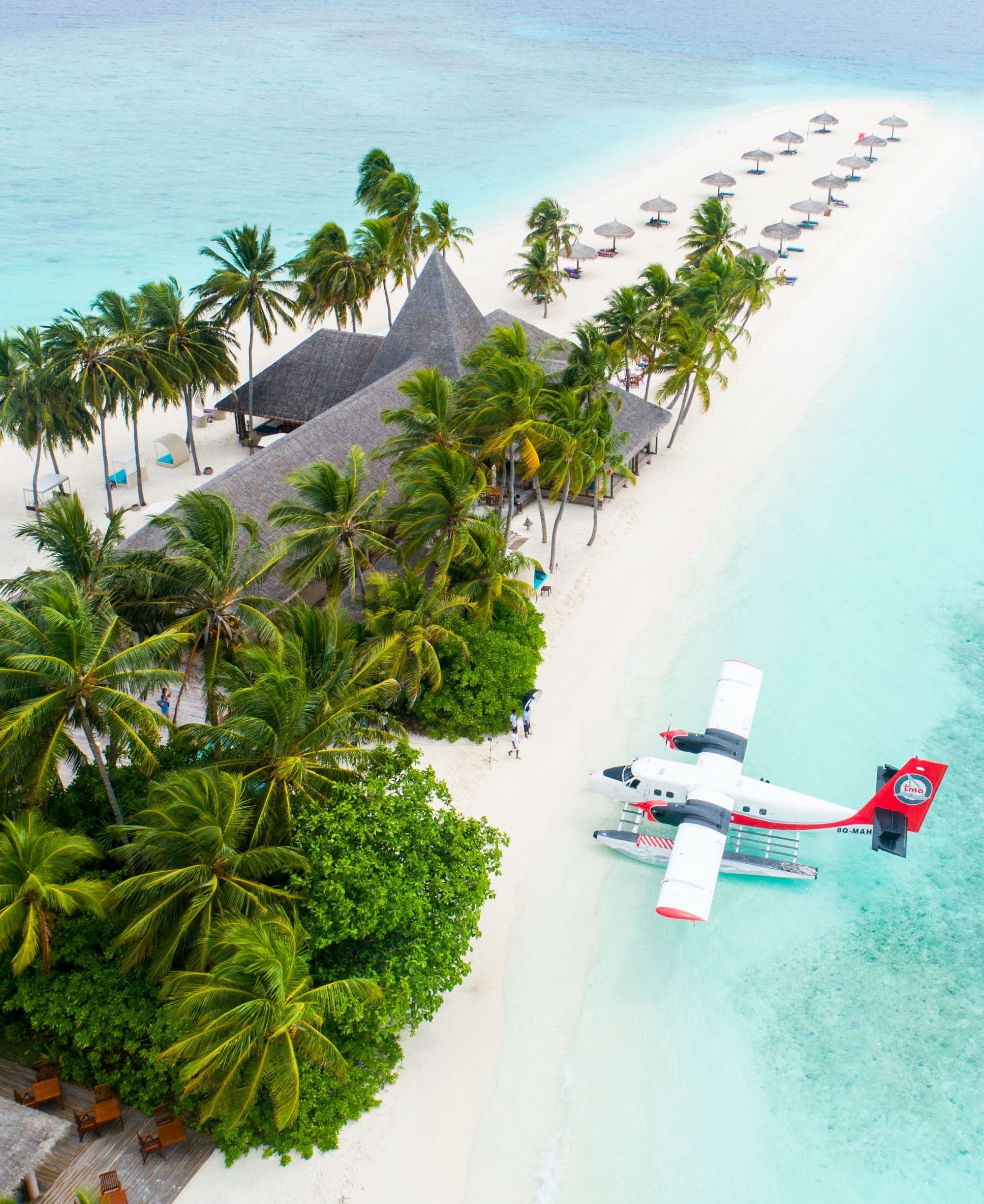 An aerial view of the island with a white colored airplane.