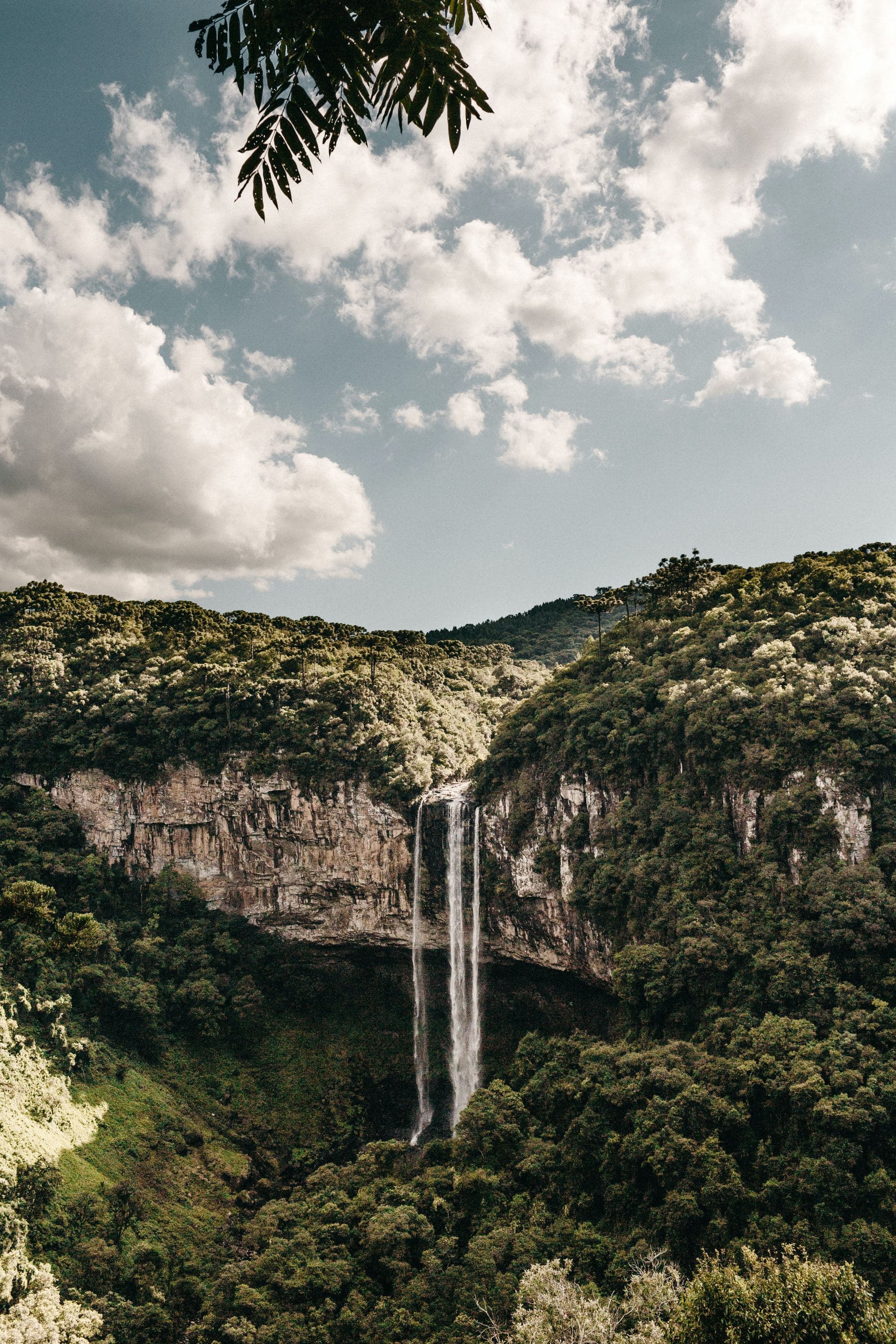 A picture of a waterfall between mountains during daytime.
