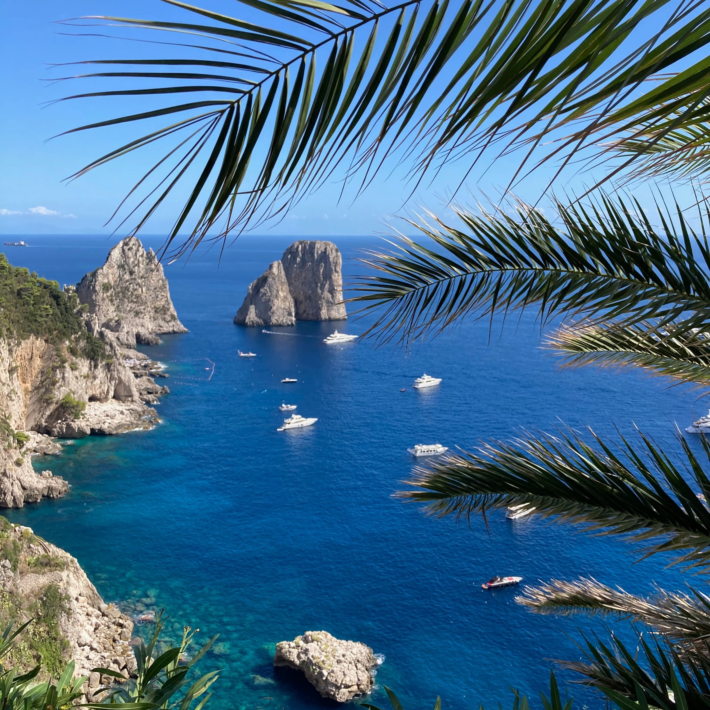 Capri coast, rock formations and boats.