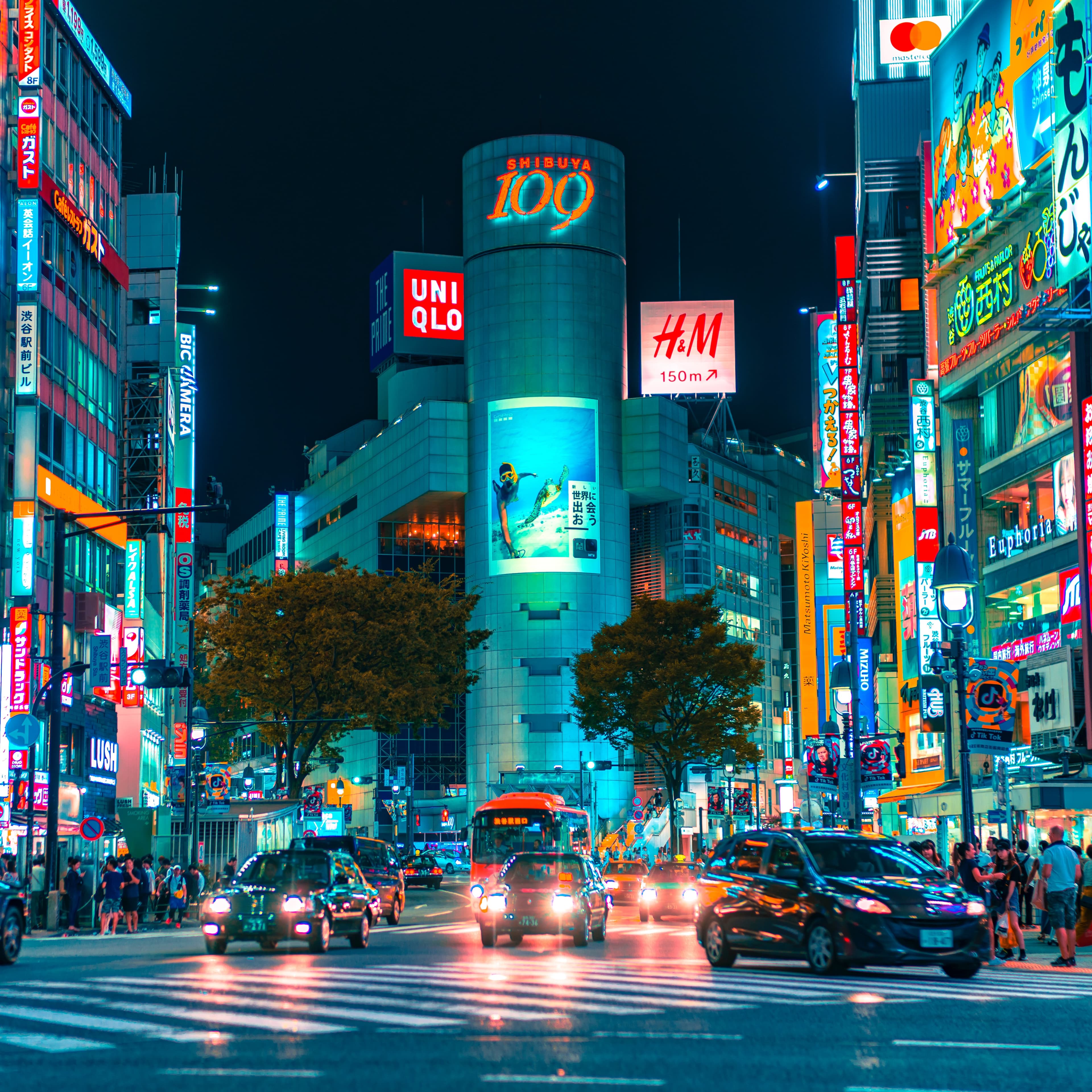 A street view at night with a lot of billboards