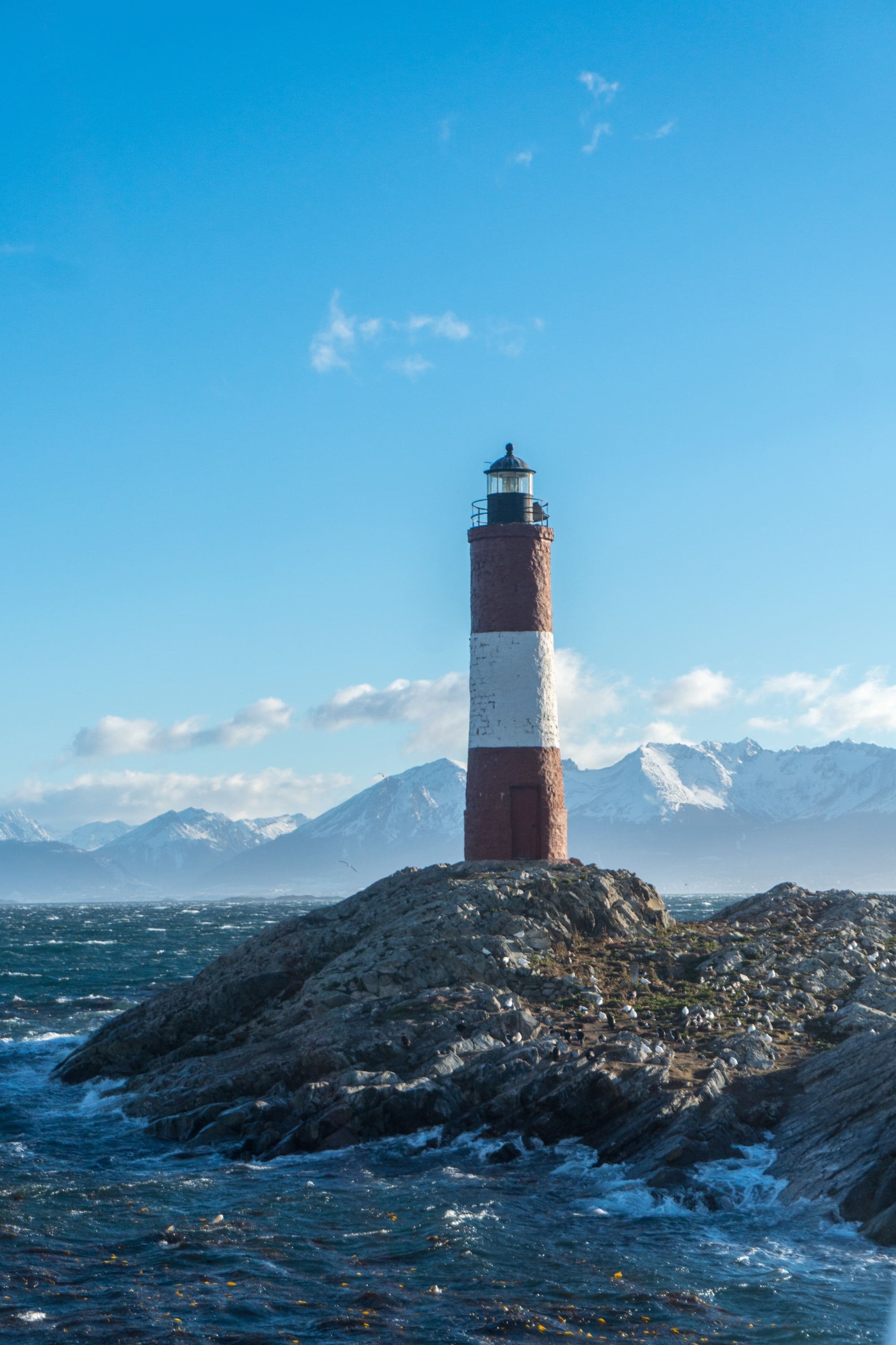 rocky shore with lighthouse in mountain region
