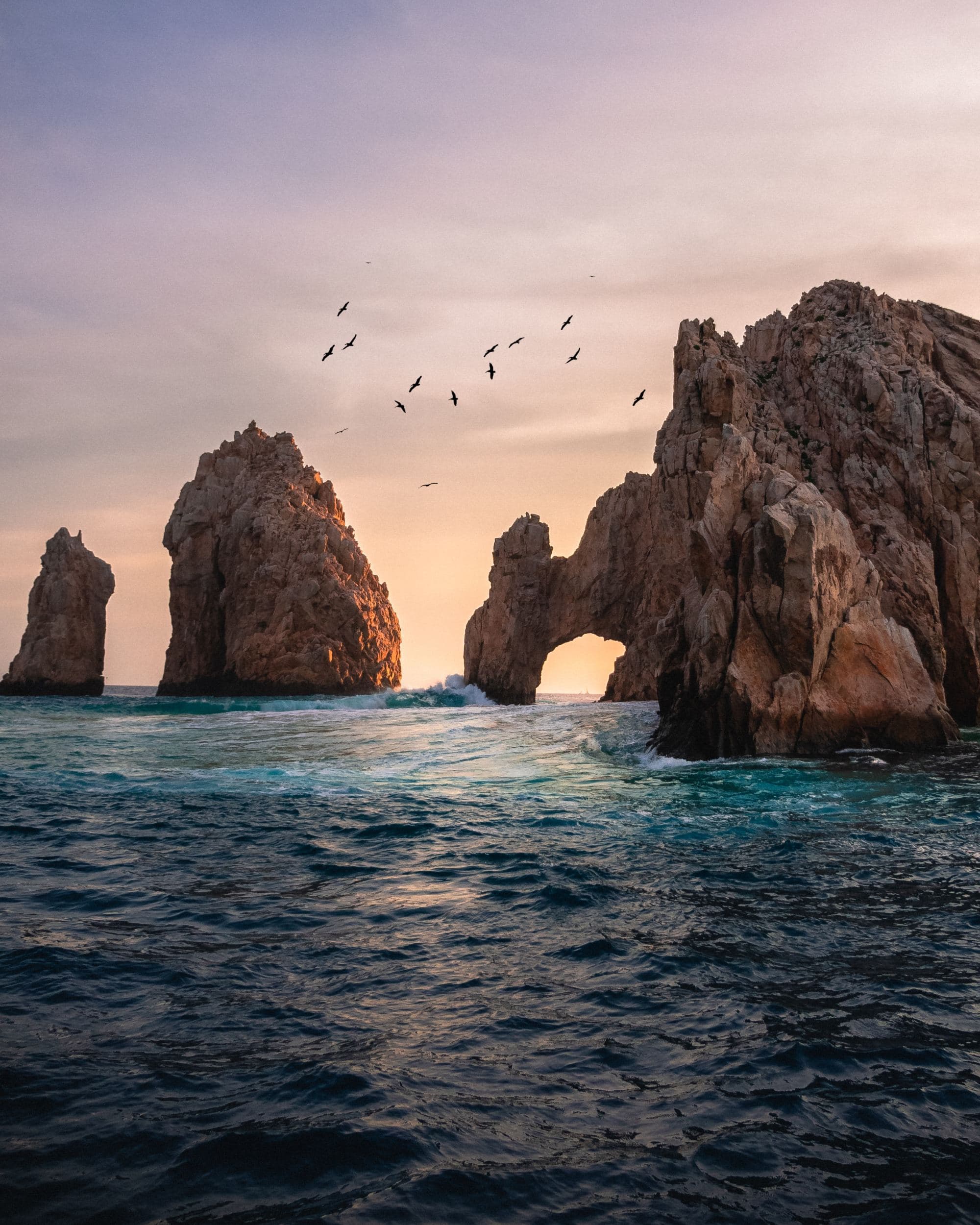 An aerial picture of rock mountains between water during daytime.