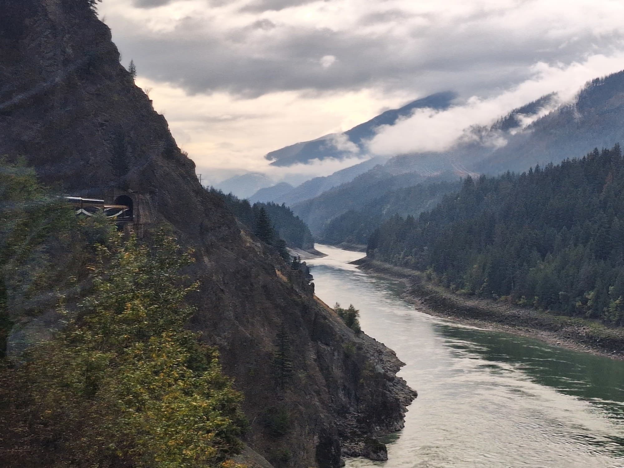 An aerial view of a lake near a mountain during daytime