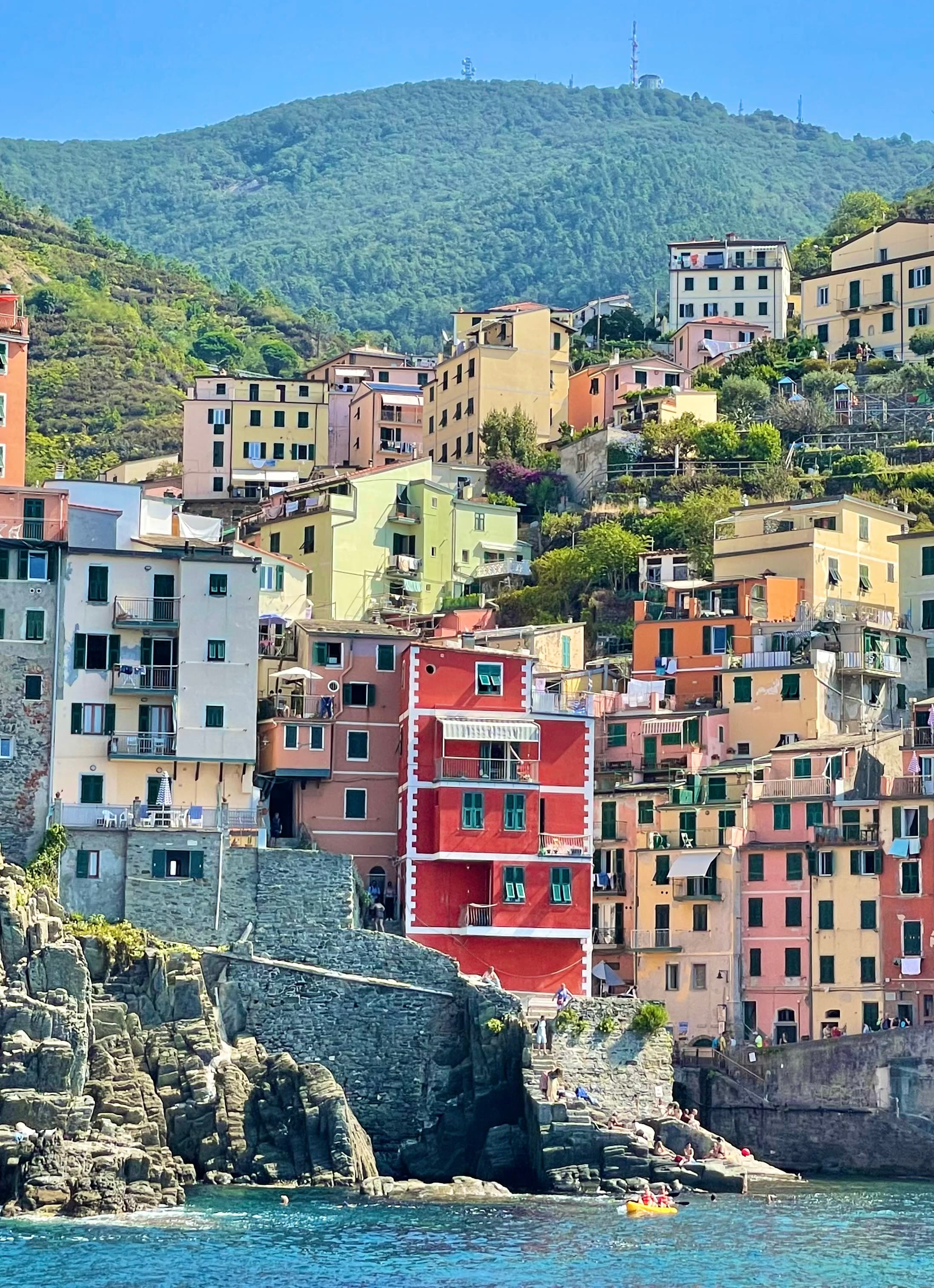 A view of colorful houses on a mountain side during the daytime.