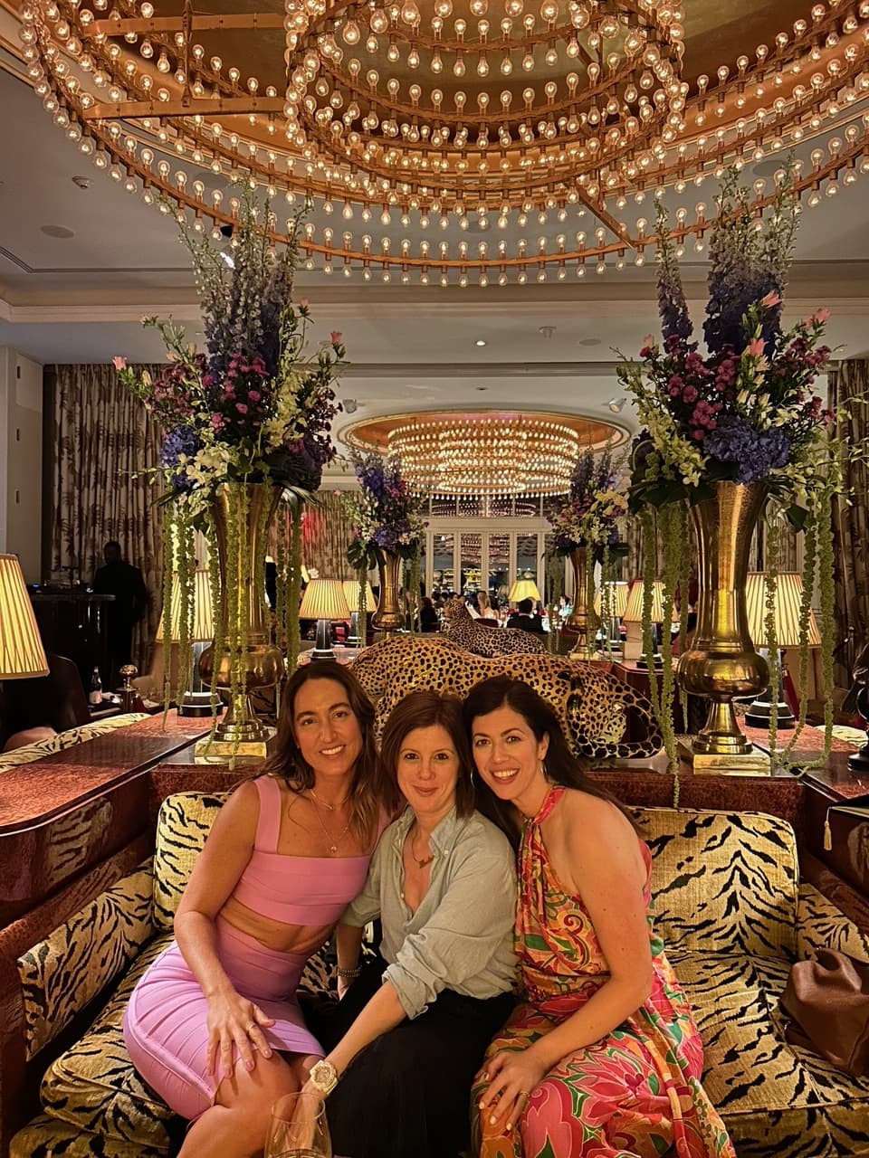 Three women posing on a couch in doors