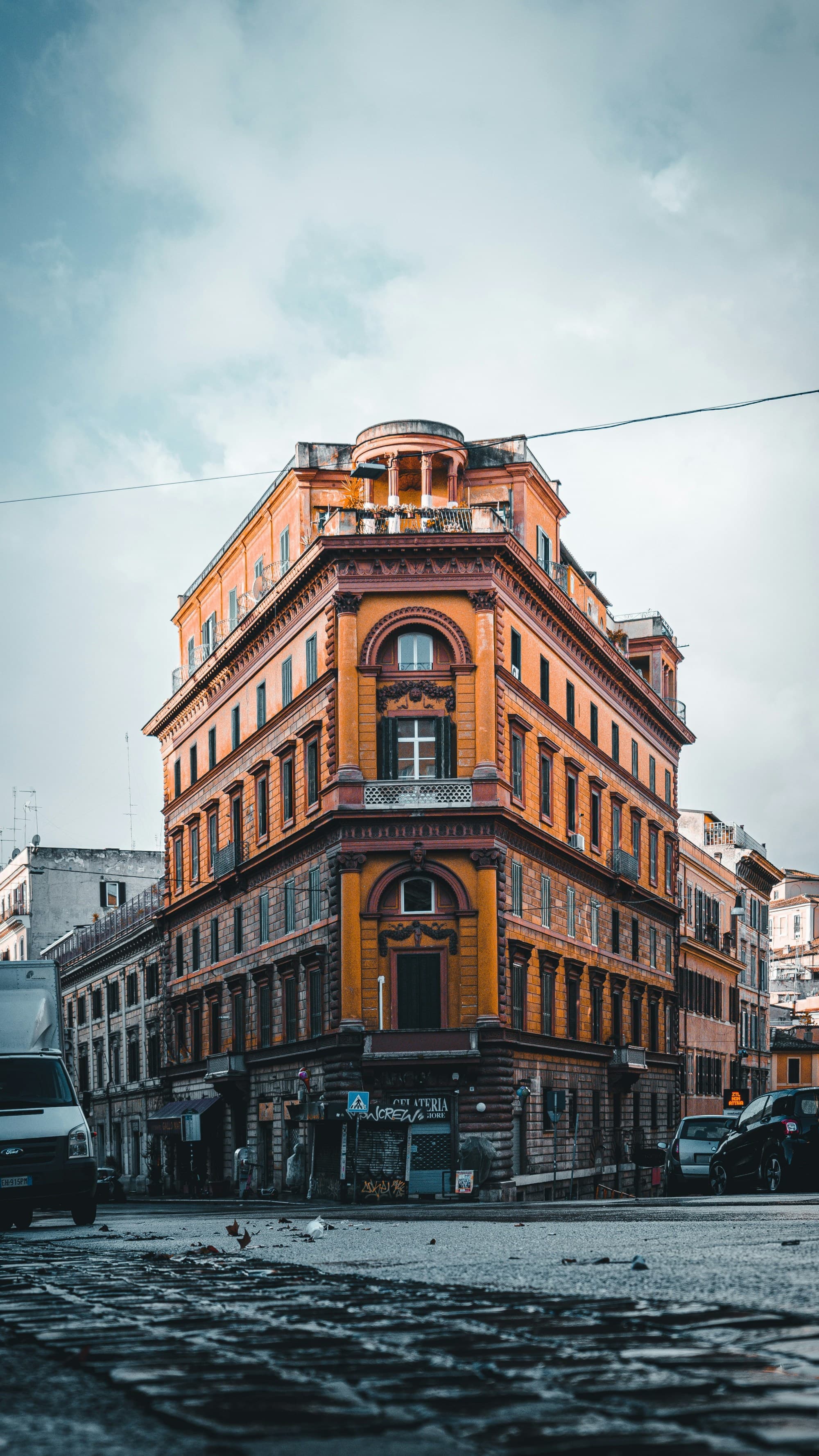 A building in Rome in the Via Cavour stands against an overcast sky on a hazy day.