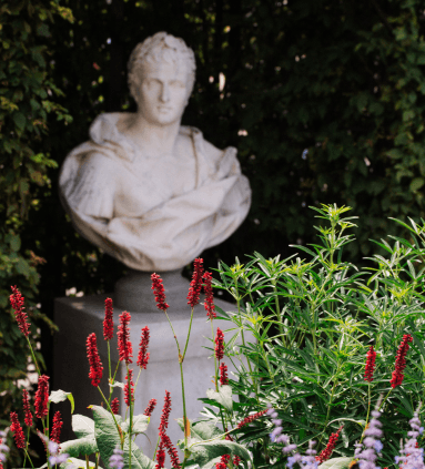 Ancient stone statue in the city park of Amsterdam.