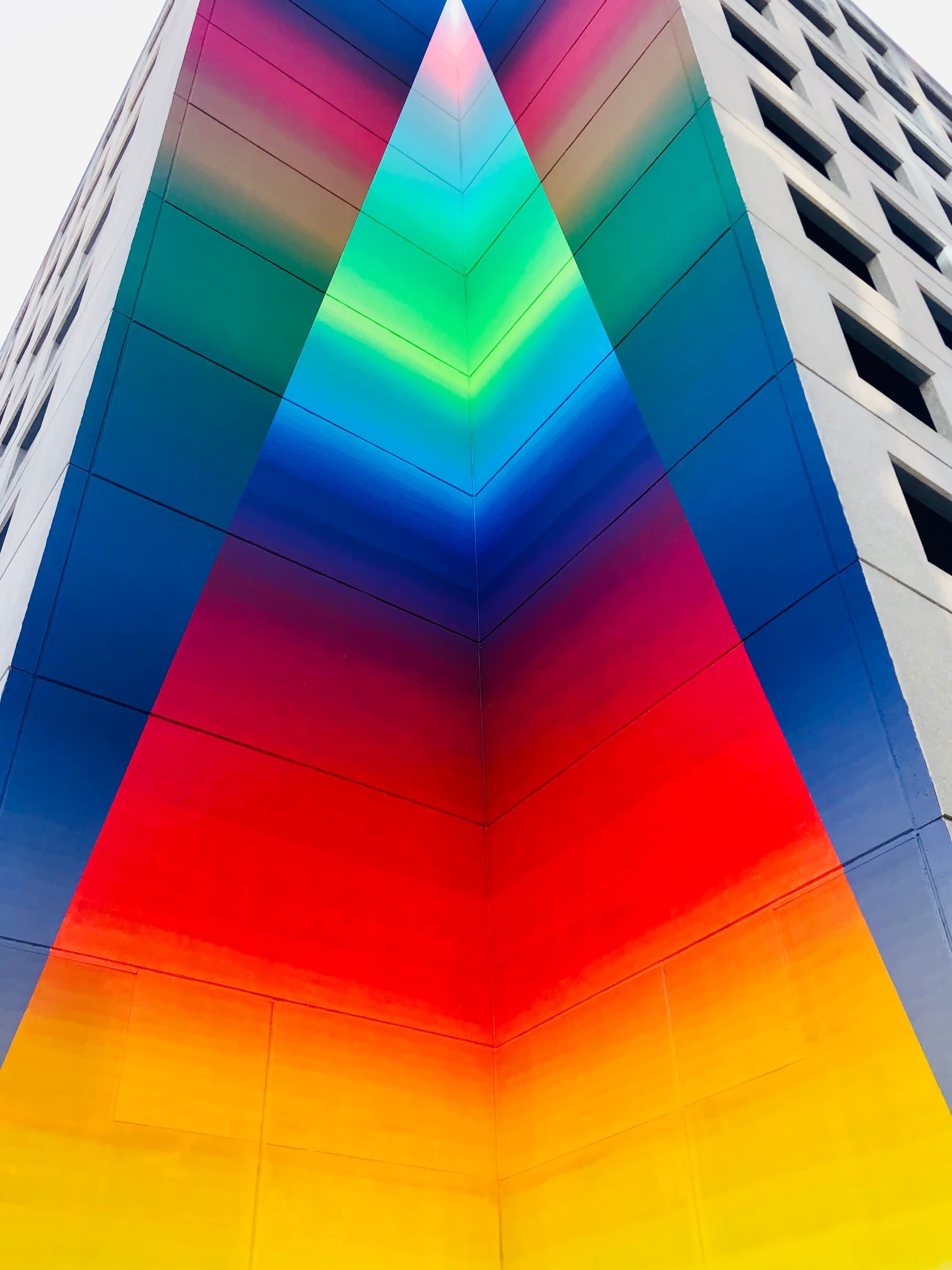 A multicolored building picture taken from a low angle.