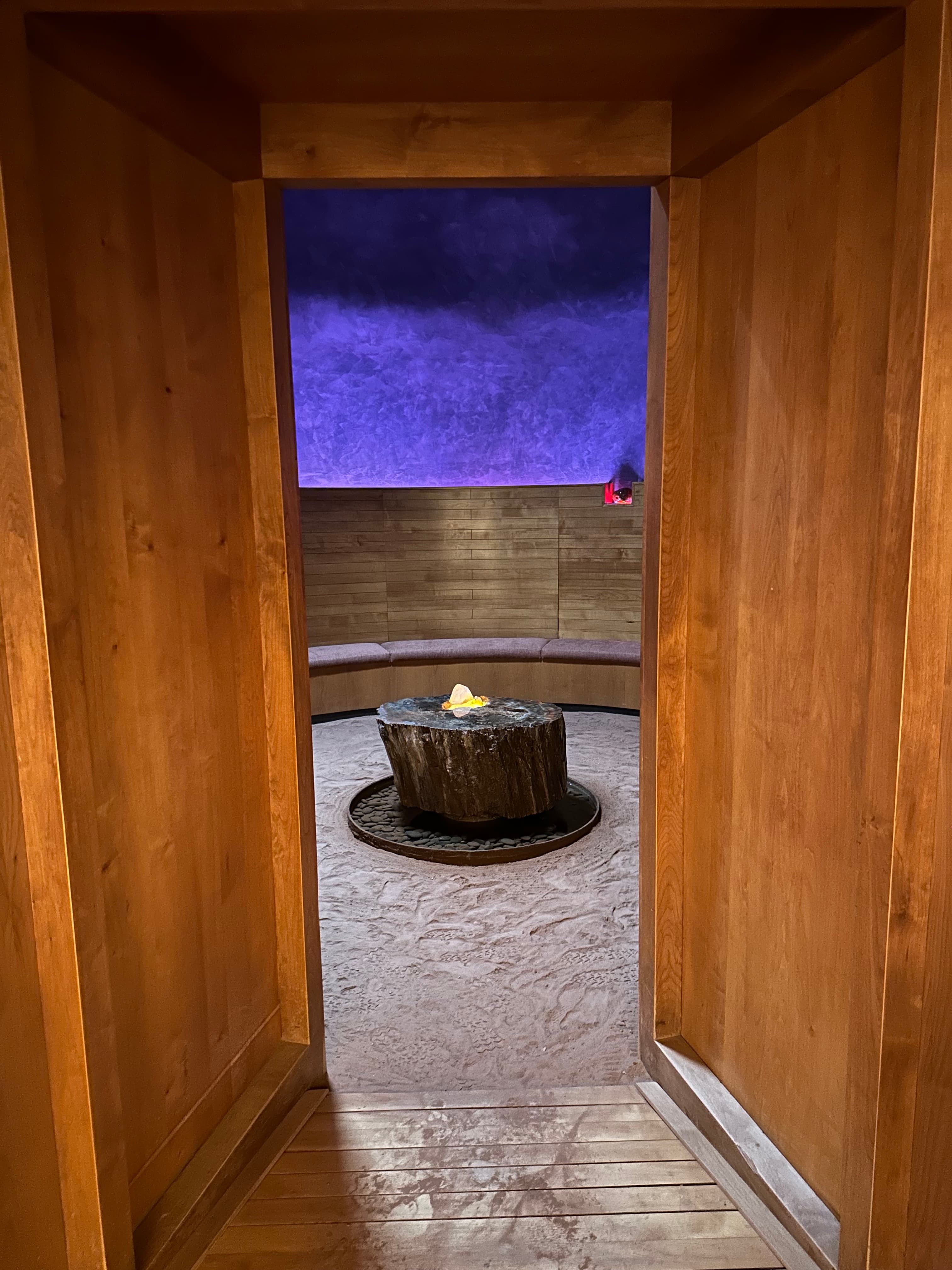 A hallway leading to a curved seating area