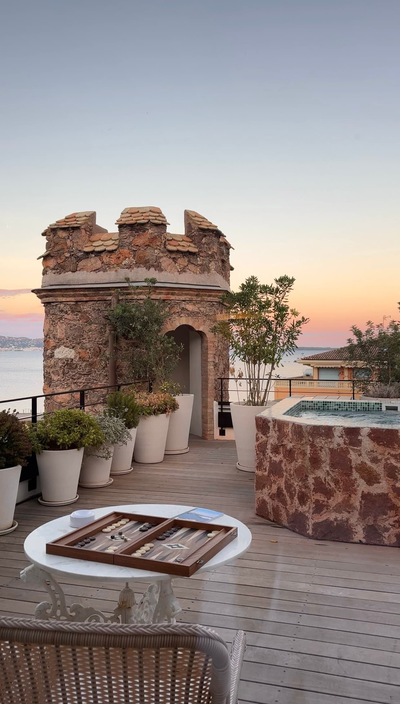 A seating area on an outdoor patio during a sunset