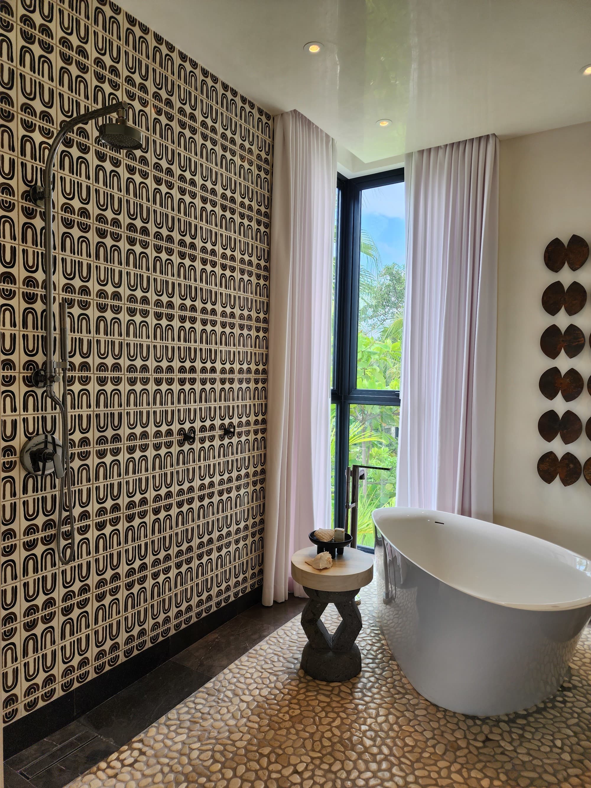 A bathroom with patterned tiles on the wall