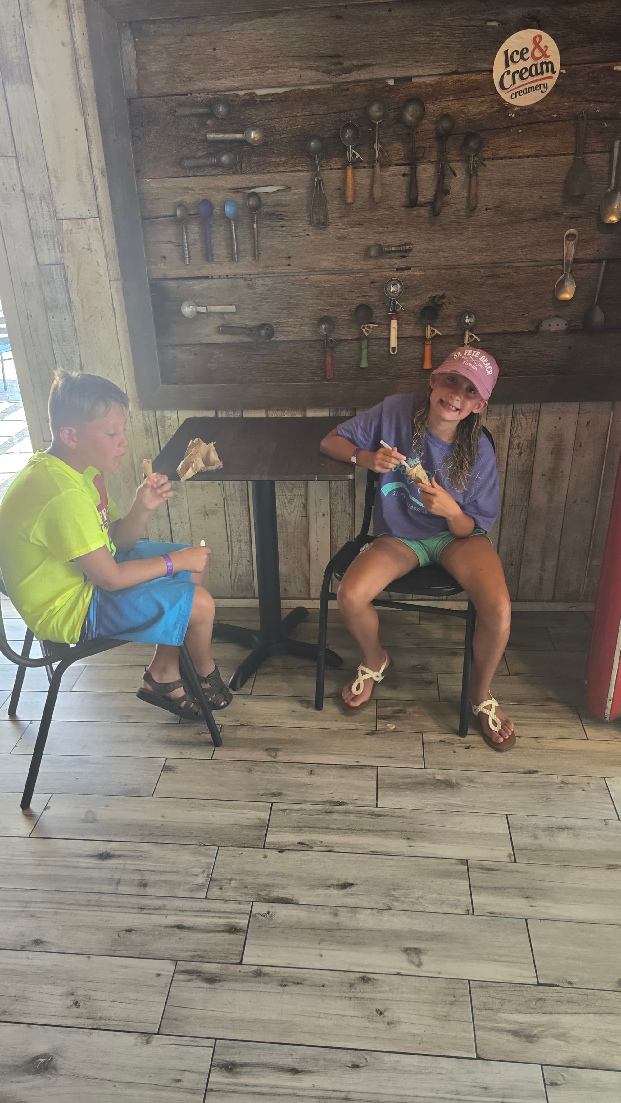 Two children sitting at a table inside