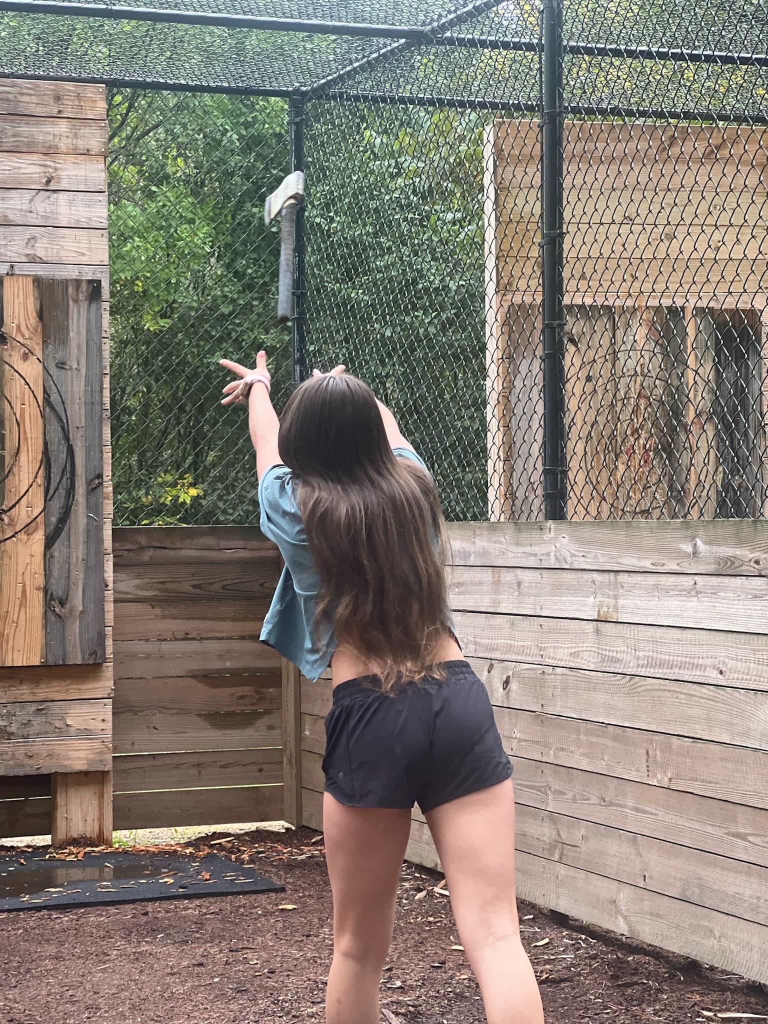 A child outside participating in an axe-throwing game