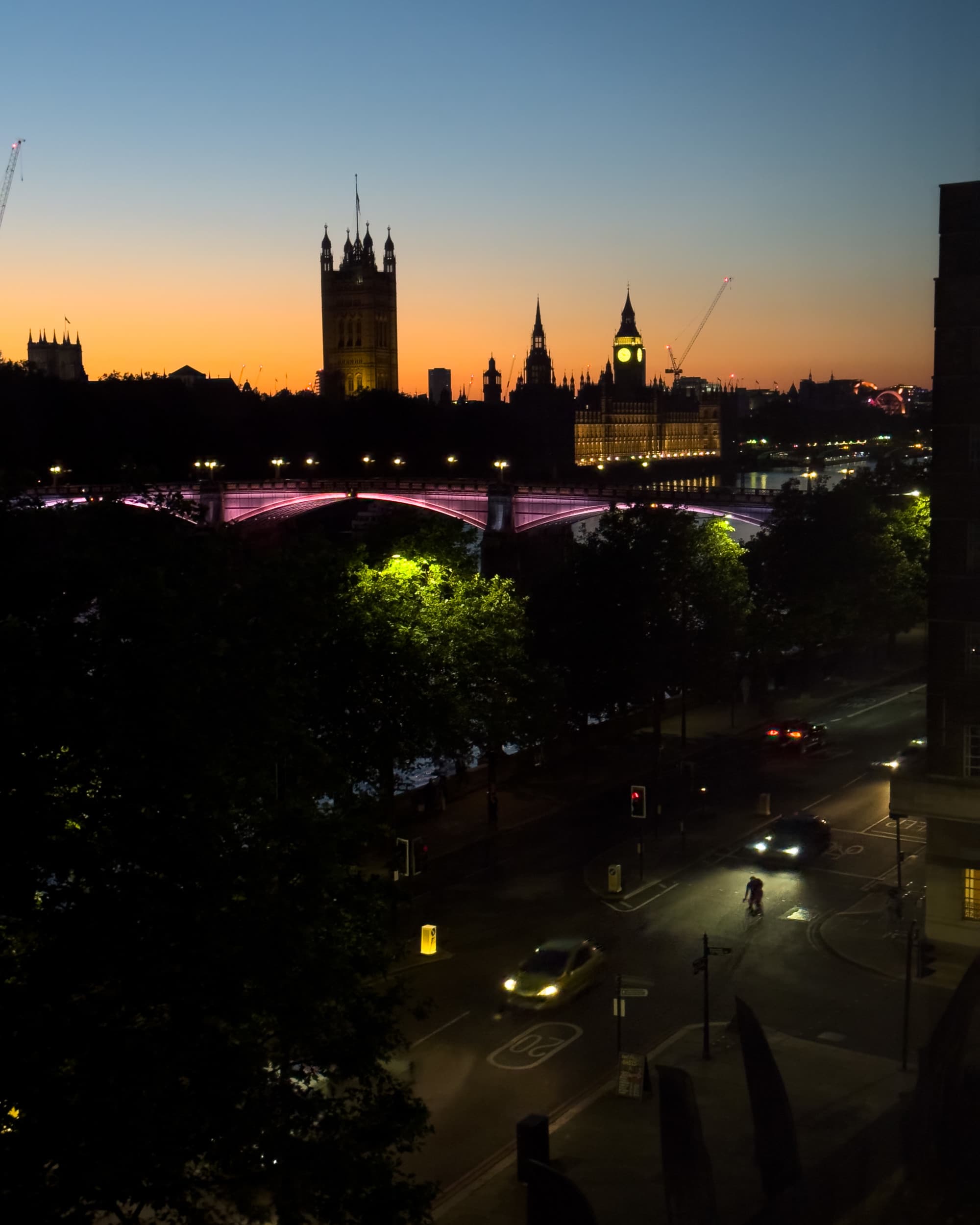 Hyatt Regency London Embankment View overlooking the city at sunset, the city is silhouetted black against the sky.