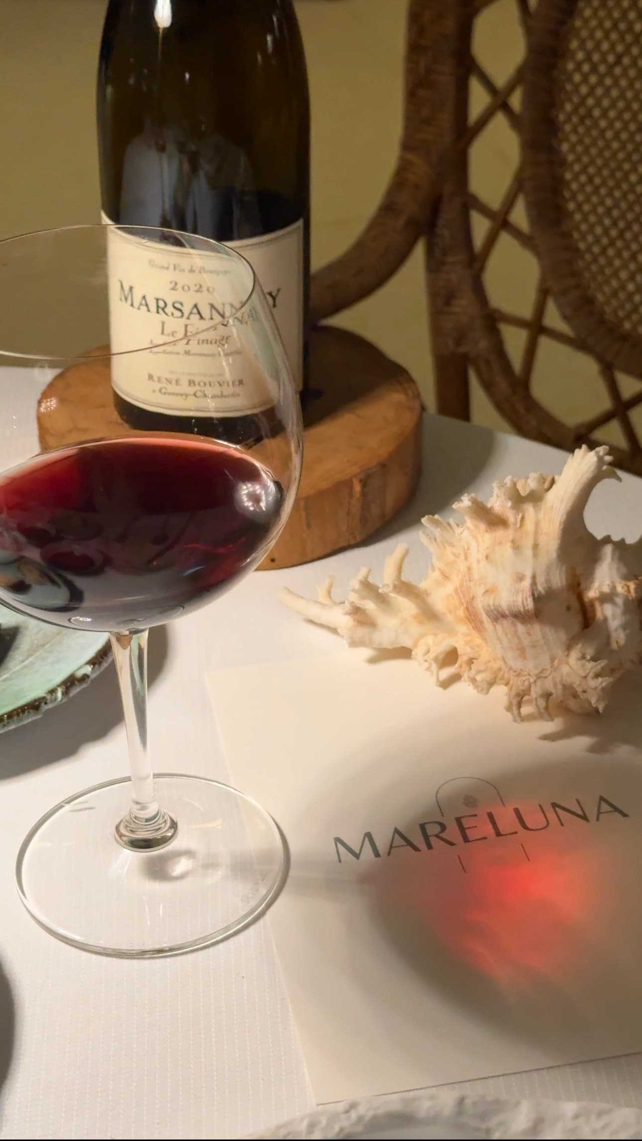 A glass of red white sitting on a table