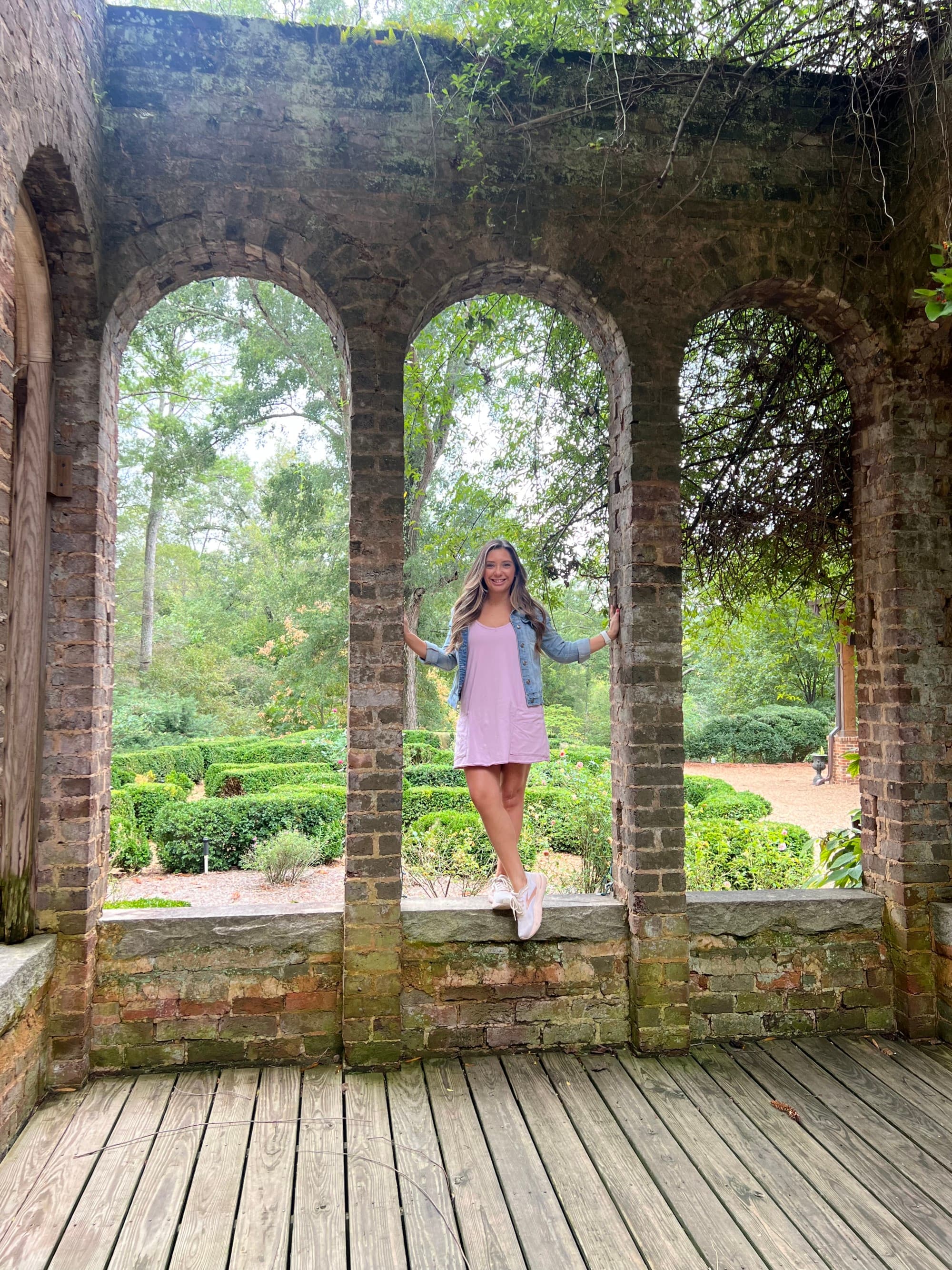 A child standing between arched brick walls