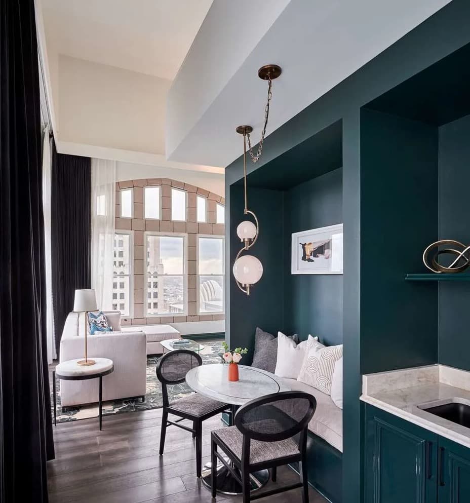 white and teal room with arched windows and modern lighting