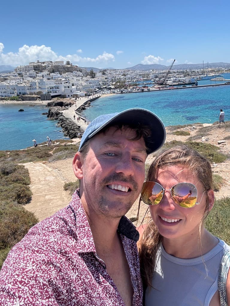 A selfie of a couple posing at the seaside.