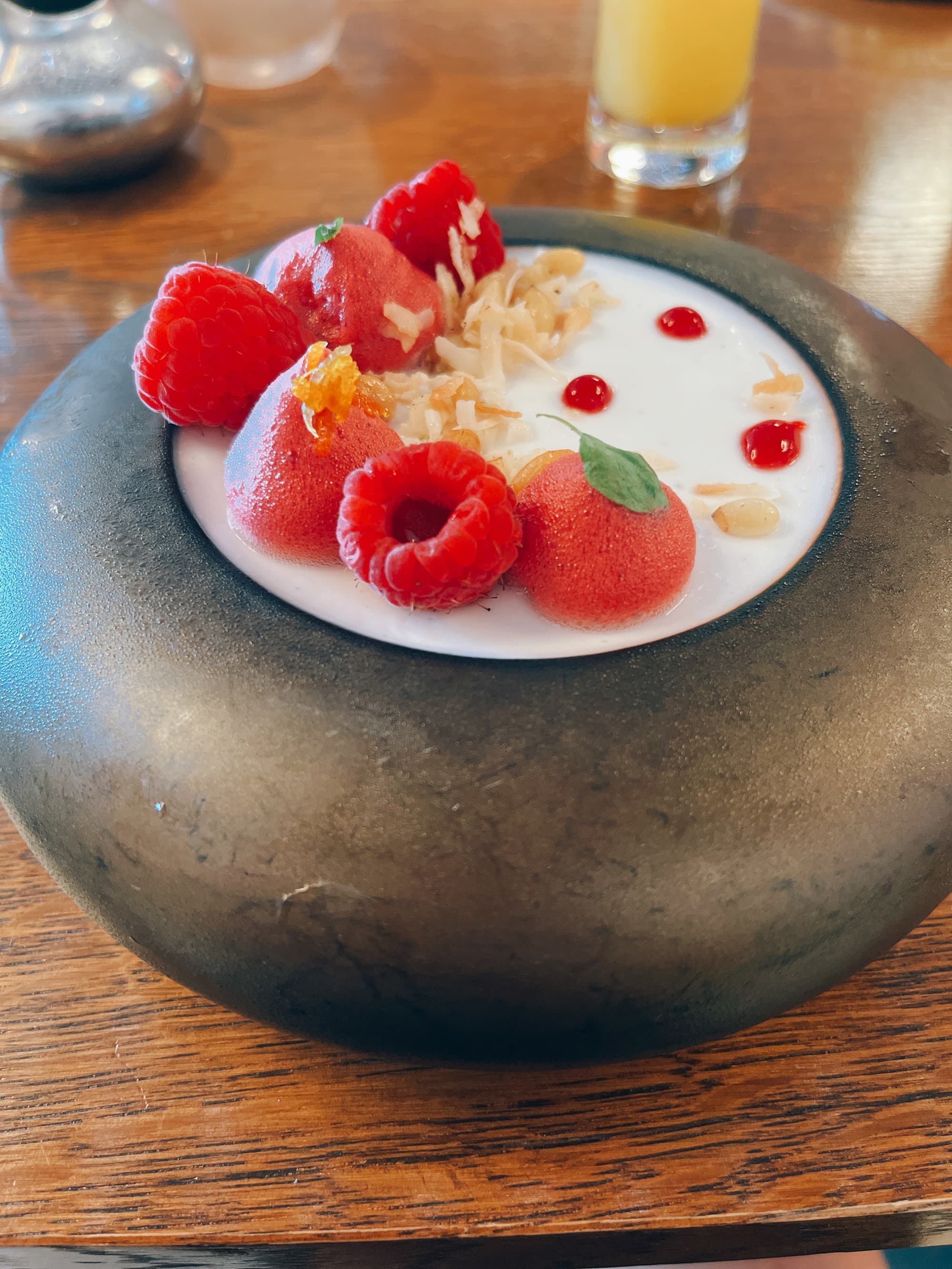 A bowl of cereal with fresh fruit on top