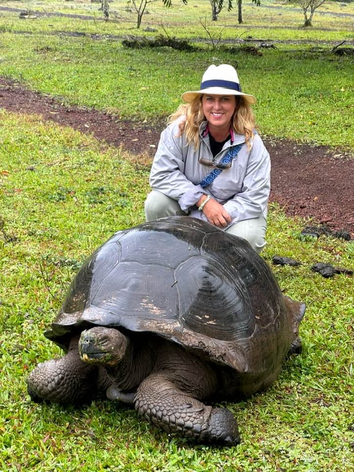 Advisor visiting the tortoise sanctuary on a sunny day.