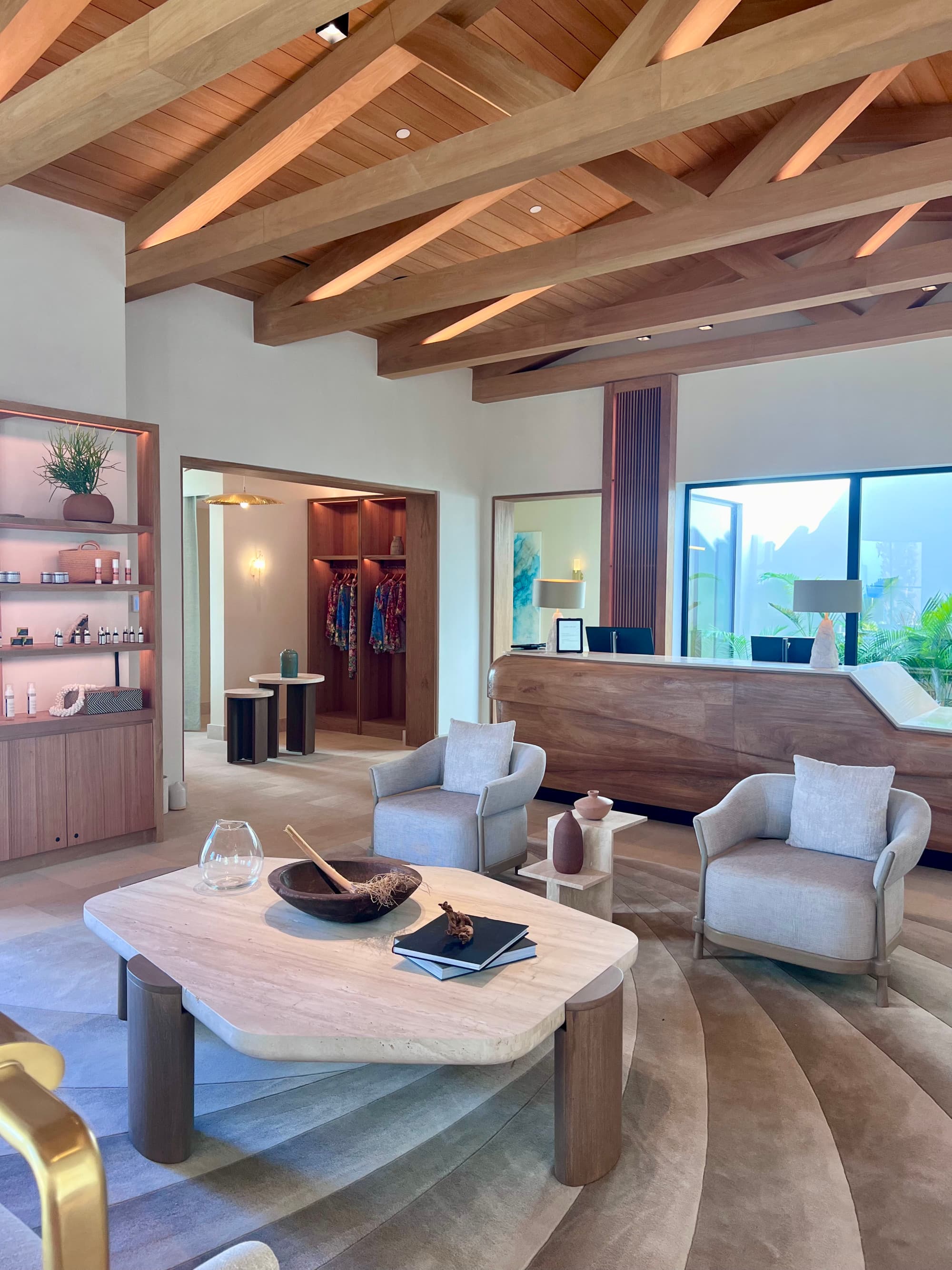 The lobby of the spa with stylish furniture, wooden beamed ceiling and reception desk.