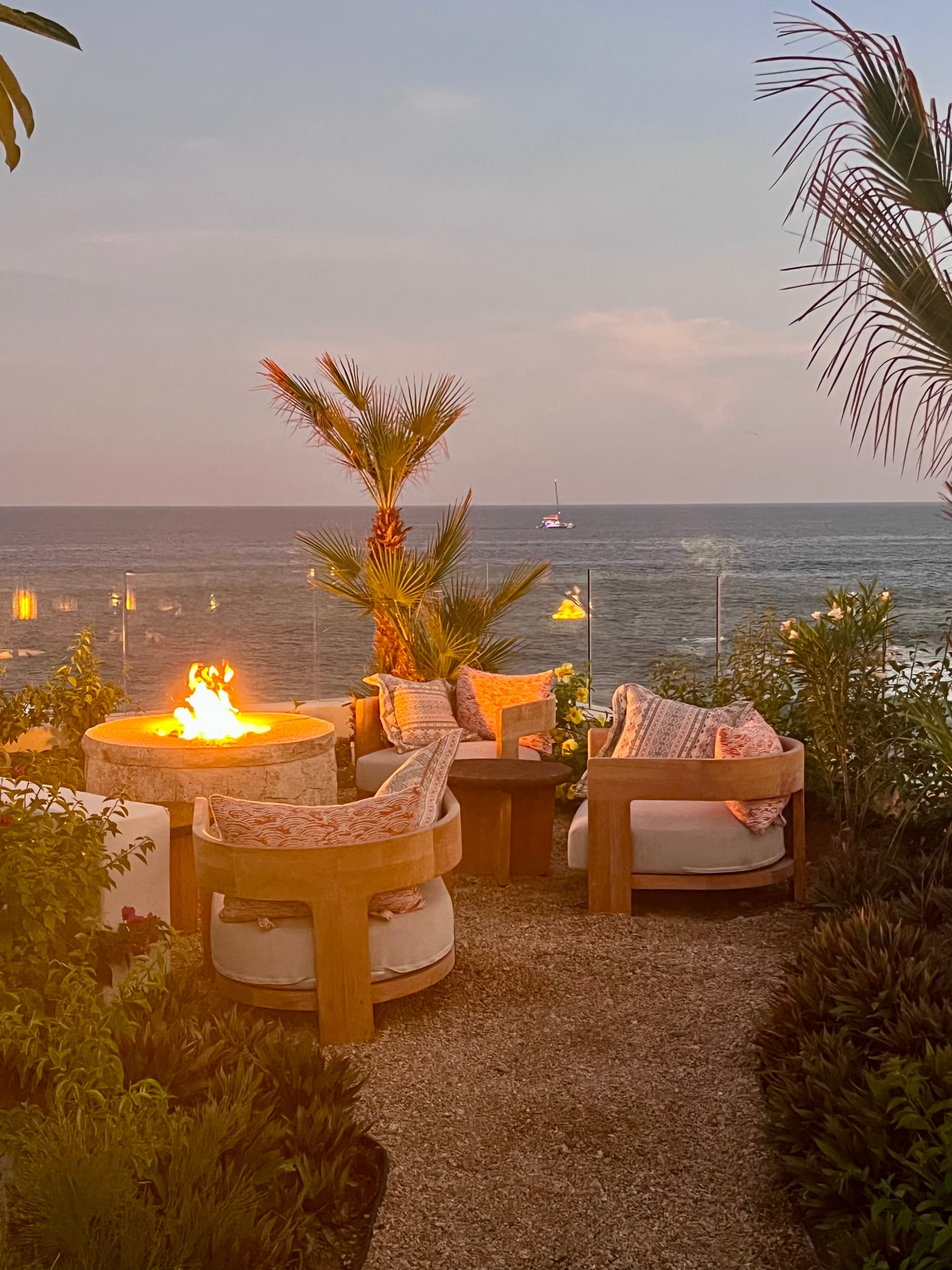 Lounge area setup overlooking the ocean at dusk.
