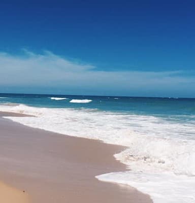 Waves under the blue sky at a beach in San Juan.